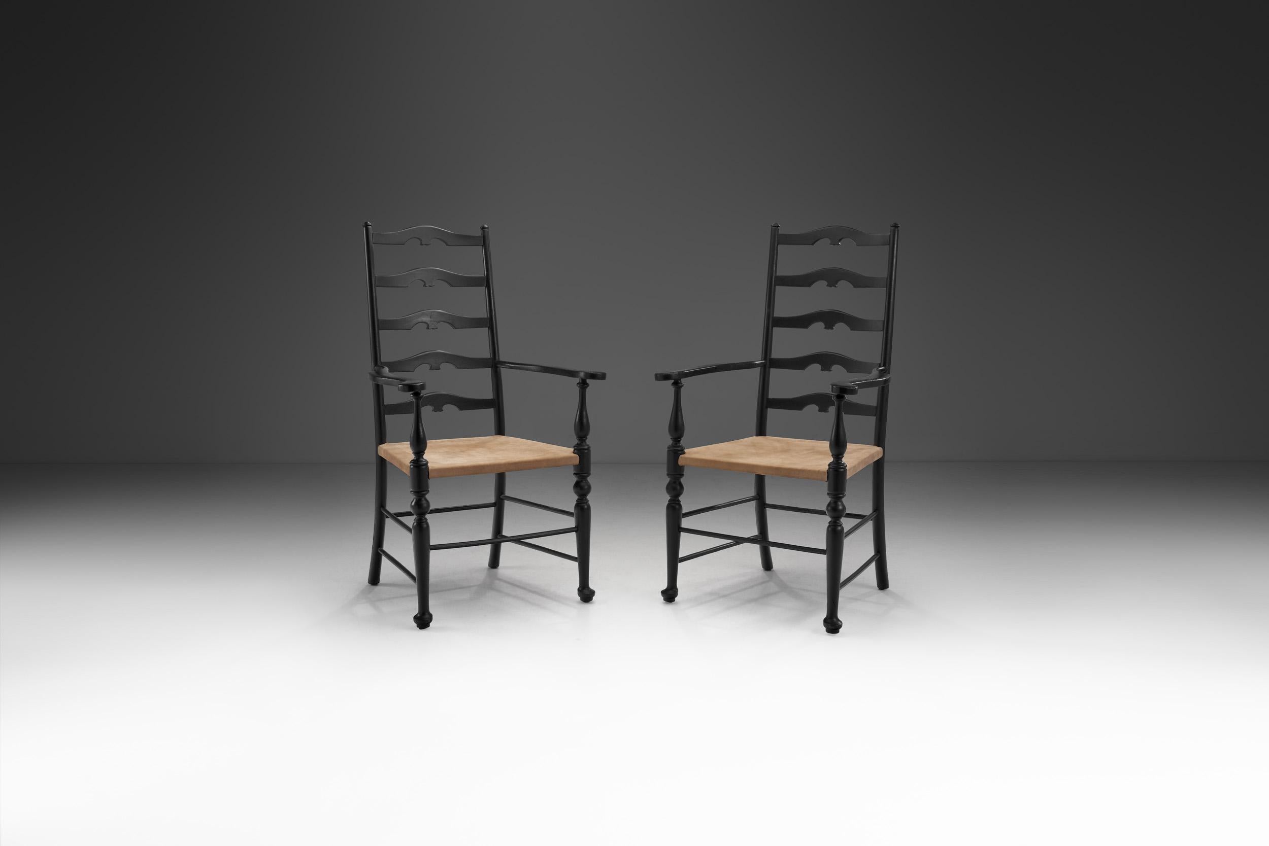 This beautiful early midcentury pair of carver chairs combines historic elements with an organic design. Using natural materials and traditional techniques, the resulting aesthetic is timeless and ever eye-catching.

Carver chairs like these have
