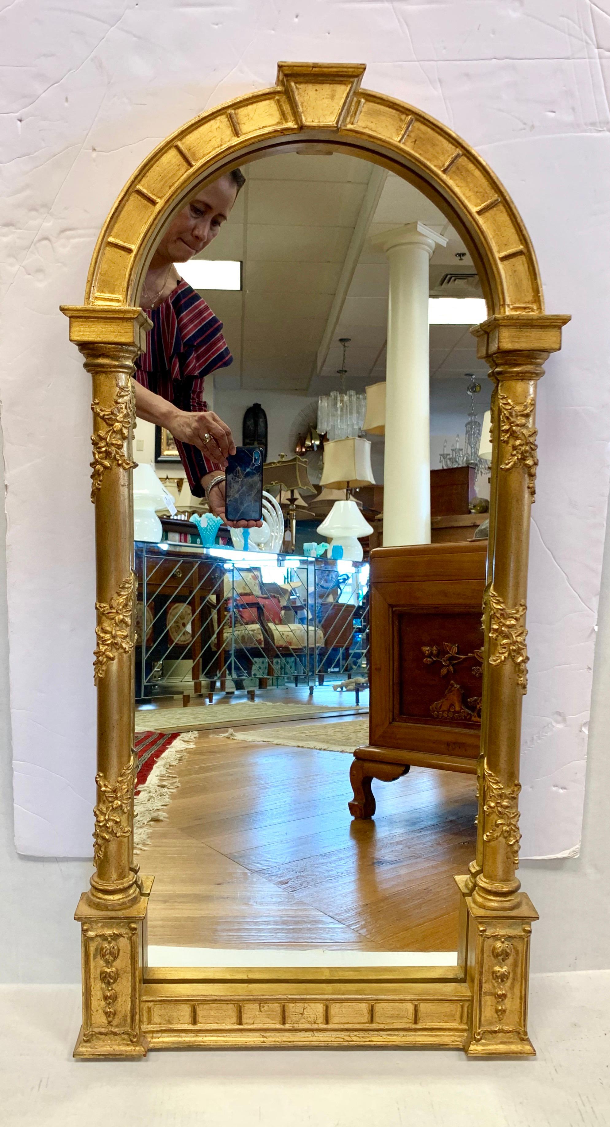 Elegant carvers guild giltwood mirror with unusual arched top.