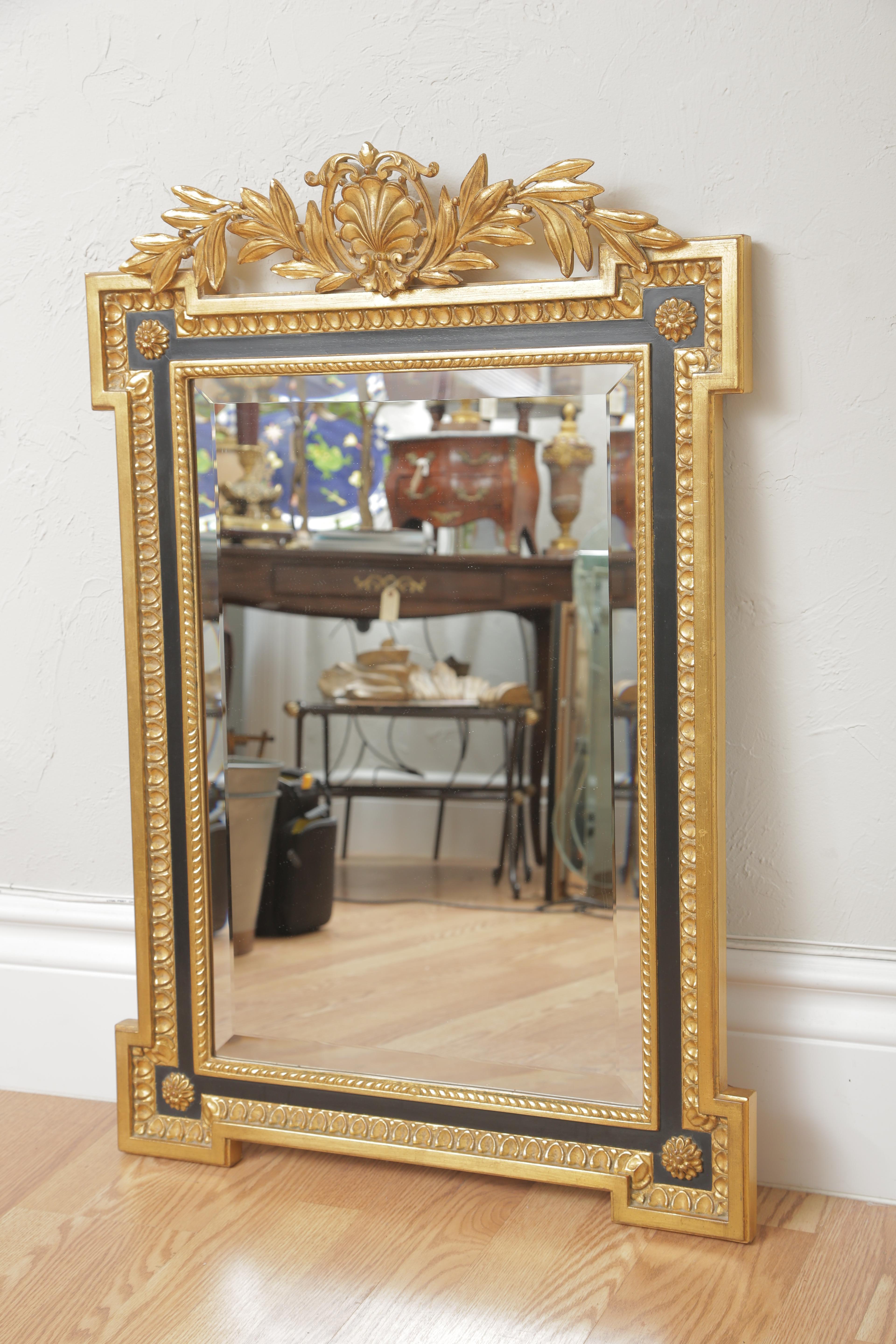 Black and gold gilded Laurel mirror by Carver's Guild.