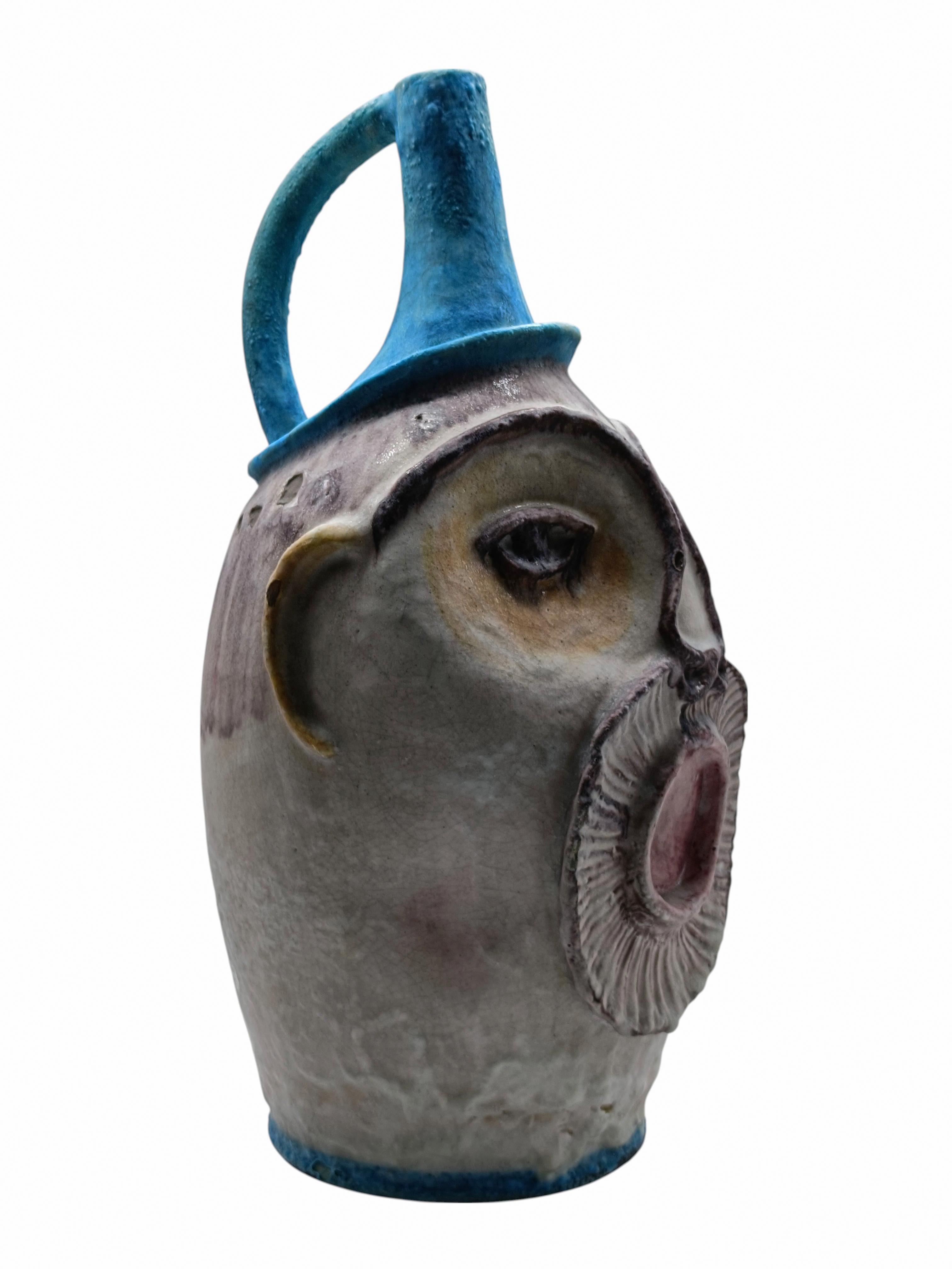 Raro e Grande vaso C.A.S. ( Ceramiche Artistiche Solimene ) Vietri Italy in ceramica smaltata, forma affusolata e leggermente bombata, con fattezze antropomorfe, che richiamano un volto stilizzato con grandi occhi e una bocca prominente. Il manico e