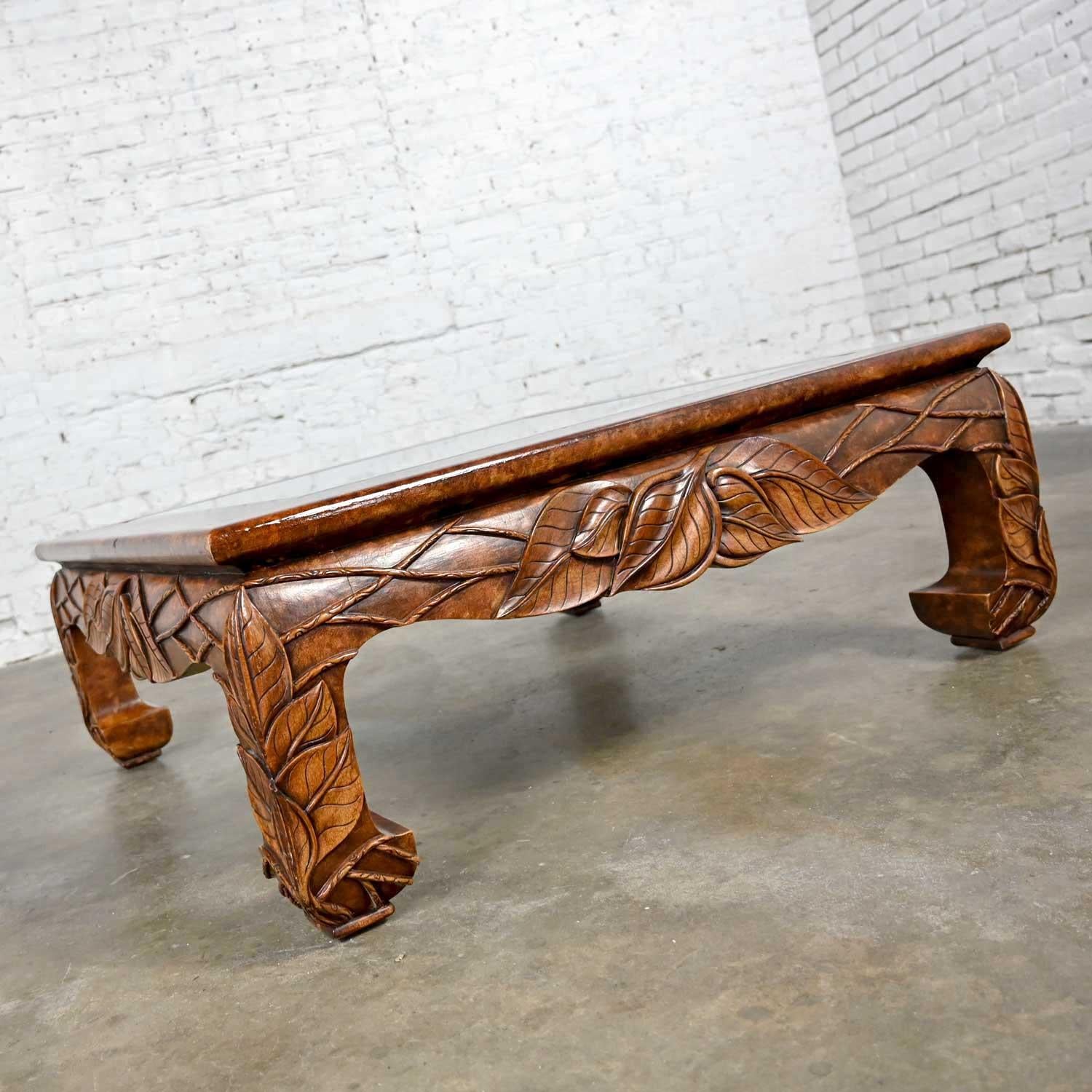 Phenomenal vintage chinoiserie Ming style chow leg coffee table with carved designs and a beveled glass insert produced by Casa Bique Ltd. in the Philippines and attributed to Robert Marcius. Beautiful condition, keeping in mind that this is vintage