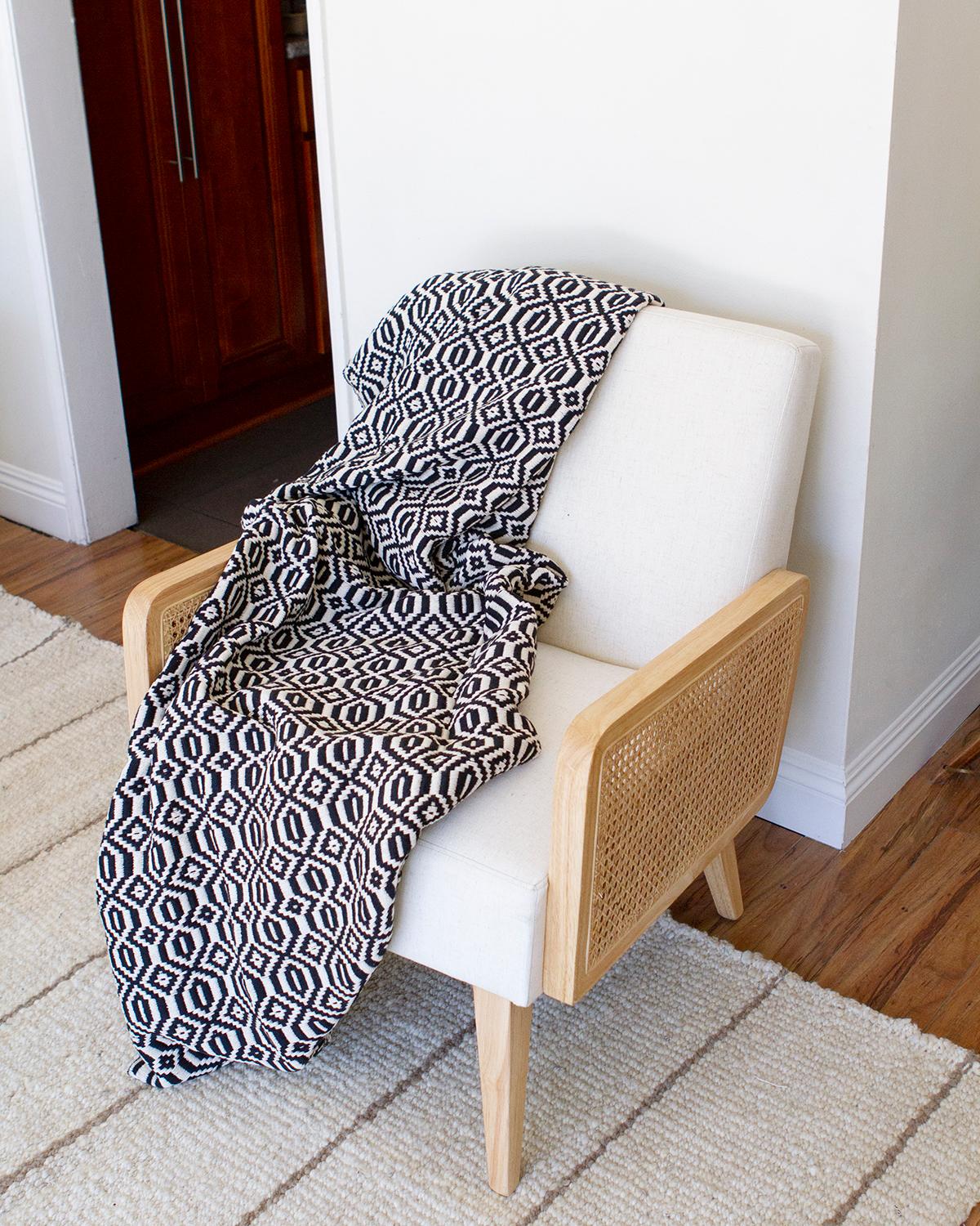 This hand made artisanal throw is made by hand in Southern Portugal. The striking geometric pattern is the perfect graphic addition to any living room. A bold statement while also being timeless. This home decoration blanket goes great with solid