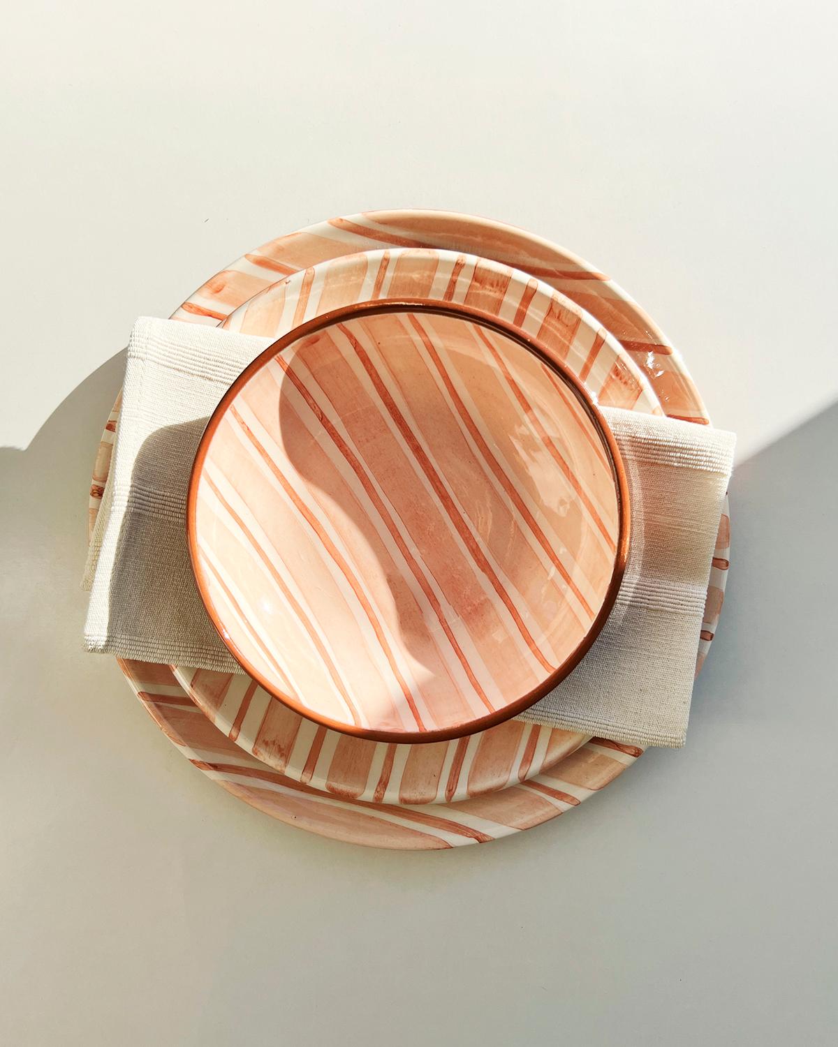 This luxurious terracotta dinnerware is handmade from ceramic with fair trade and locally sourced materials from Europe. Each piece is crafted with meticulous attention to detail for a high quality and rustic look. The striped graphic pattern gives