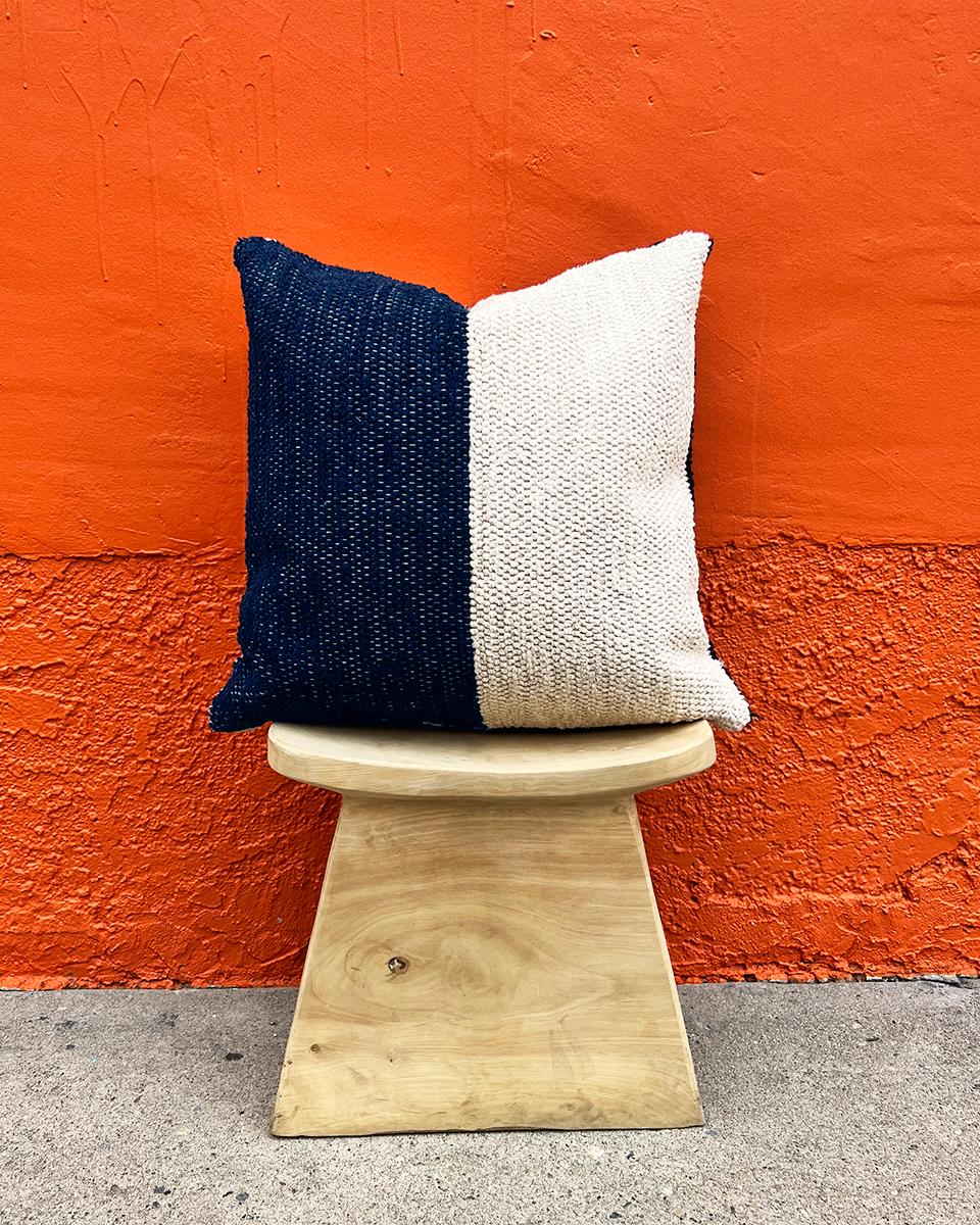 A geometric textured throw pillow for your couch or bed. This navy and cream cotton throw pillow is made from thick handwoven cotton and is perfect for a high traffic area like the living room couch. Put two matching pillows on either side of the