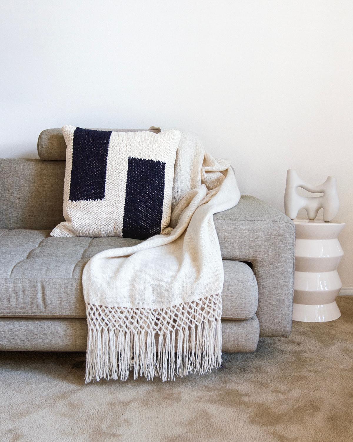 This navy and cream cotton throw pillow is made from thick handwoven cotton and is perfect for a high traffic area like the living room couch. Put two matching pillows on either side of the couch or get multiple patterns in the same color. The