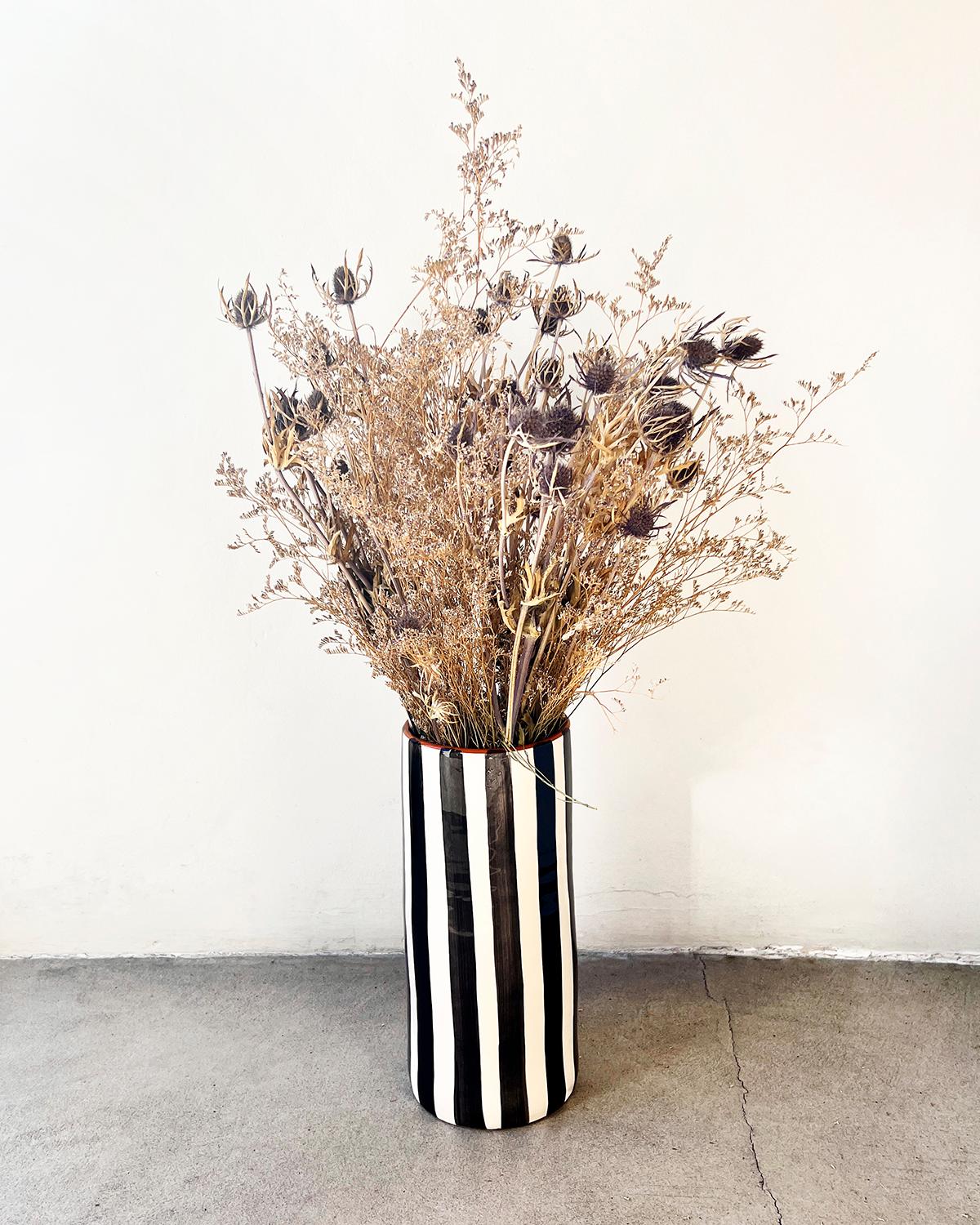 A unique vase for to beautify your home. This Casa Cubista vase is an artisanal piece of home decor made from terracotta with bold, black and white stripes. Handcrafted in Europe, this fair trade and locally-sourced vase is the perfect addition to