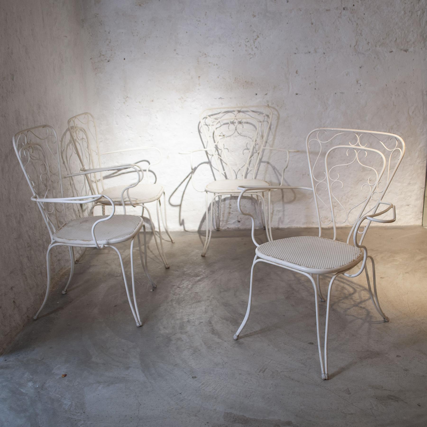 Set of four lounge chairs by Lio Carminati in white painted metal Italian production mid 50's, the chairs are deliberately left with their antique patina.