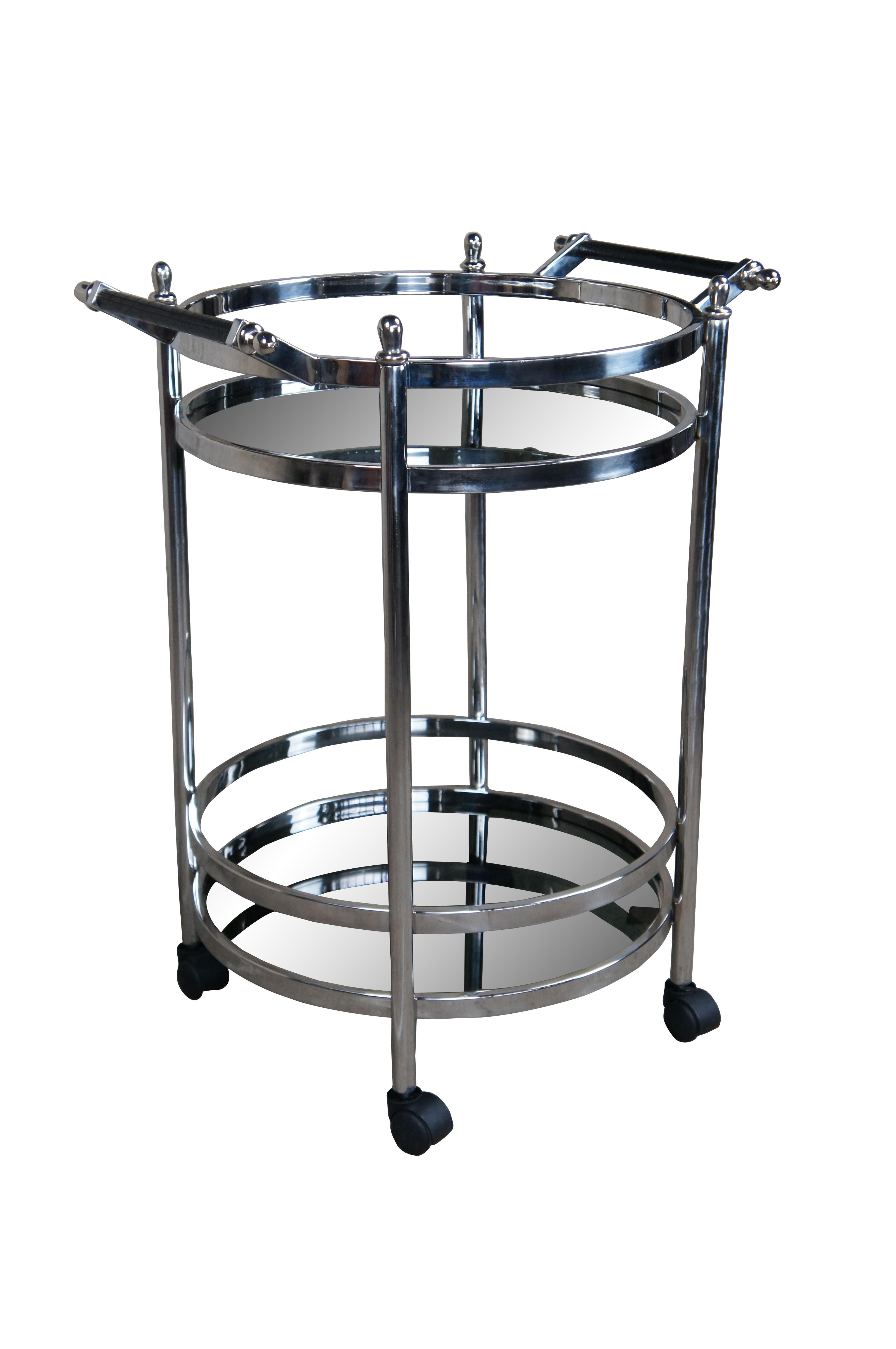 Casa Padrino Designer luxury bar trolley. Made from nickel plated Stainless steel and smoked glass. Features a round form in Art Deco / Post Modern manner with two tiers, leather handles and wheels for ease of movement. 


Dimensions:

22