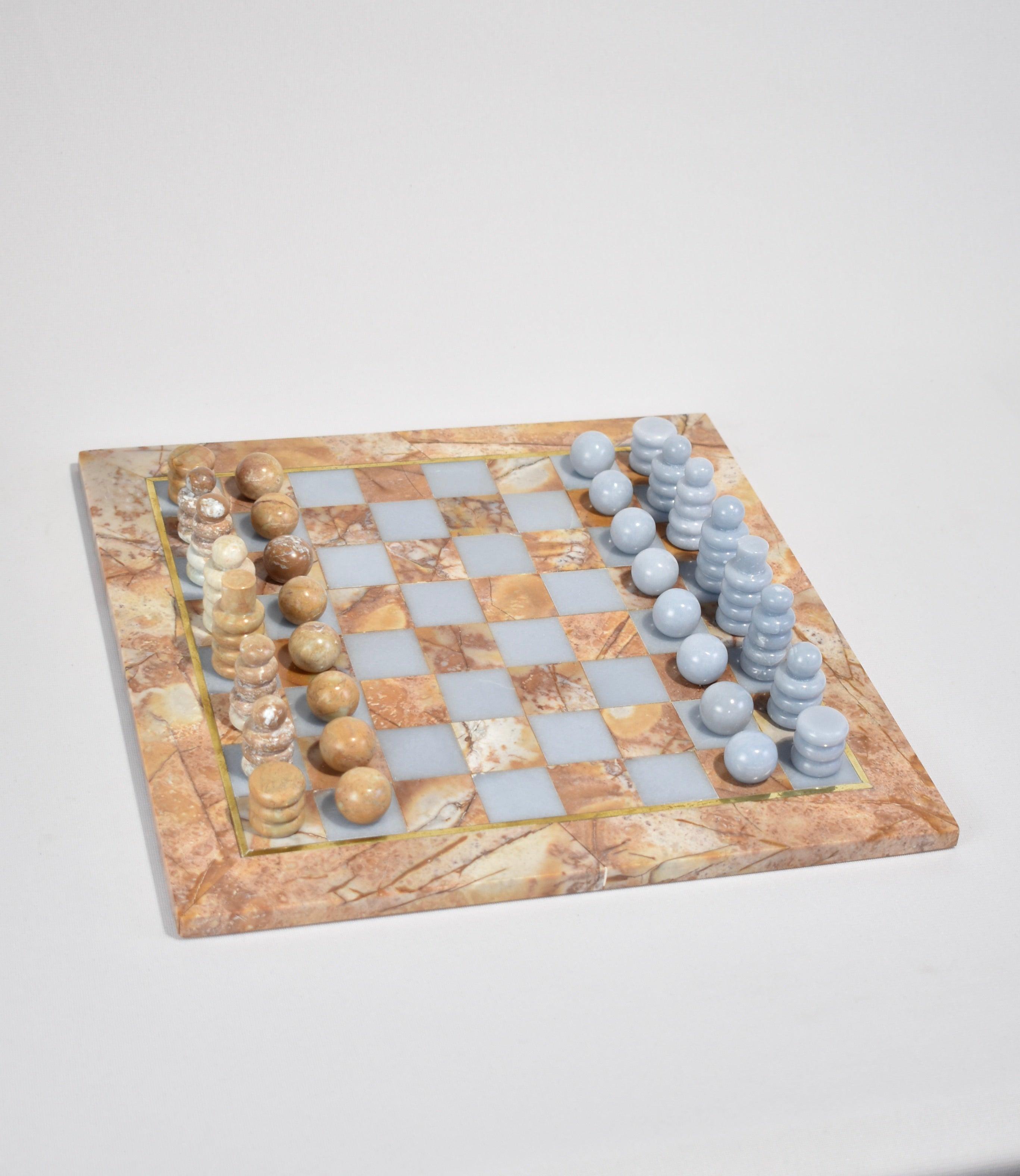Introducing the chess set by Casa Shop, the second design in our stone collection handmade by artisans in Perú. 

Each set features hand-carved pieces and a board in Soapstone and Soft Blue Celestine. The board is accented in brass inlay and comes