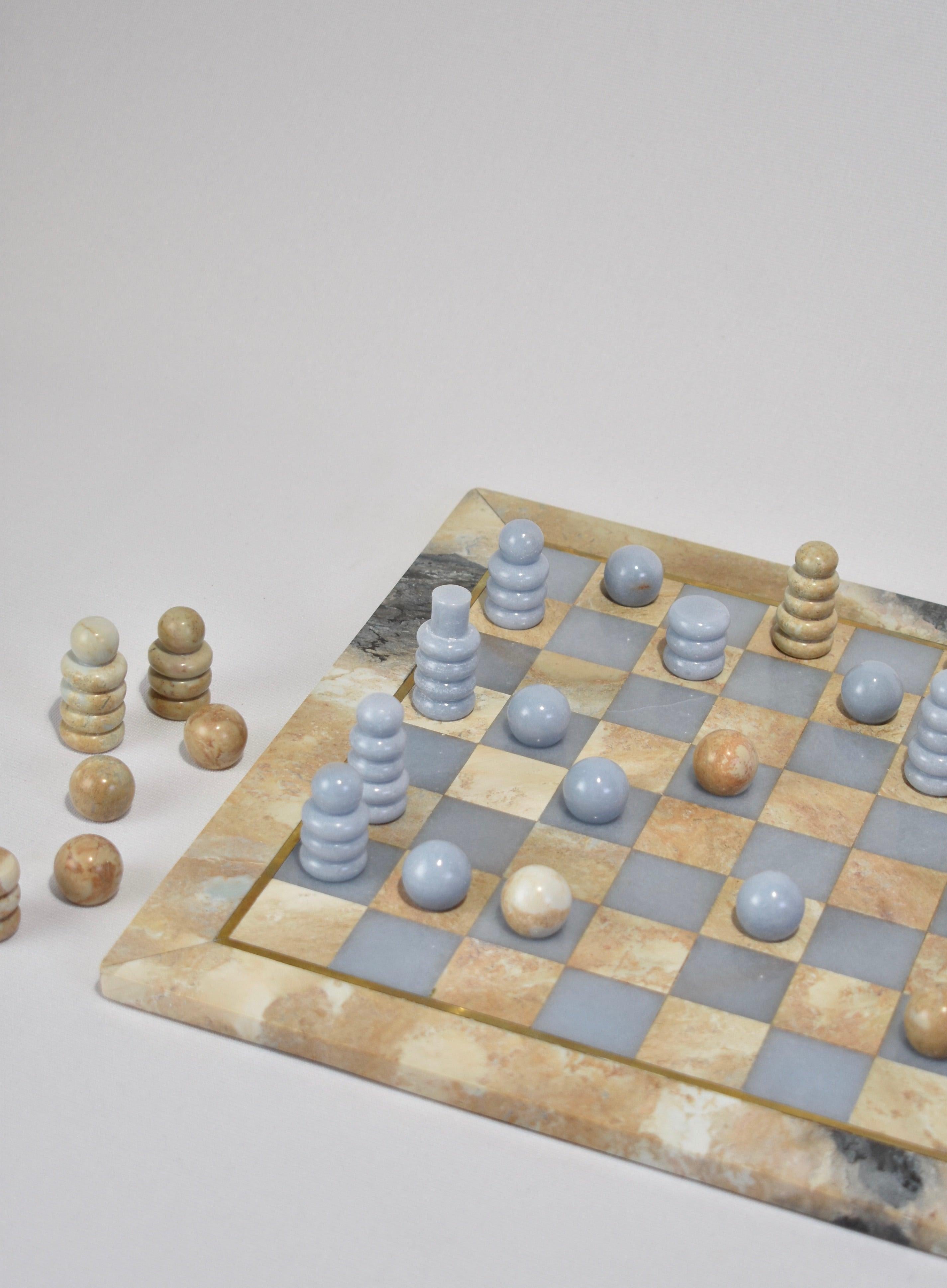 Introducing the Chess Set by Casa Shop, the second design in our stone collection handmade by artisans in Perú. 

Each set features hand-carved pieces and a board in Soapstone and Soft Blue Celestine. The board is accented in brass inlay and comes