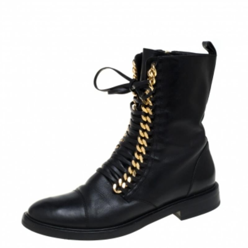 Casadei updates an ageless silhouette with an element of edge with their City Rock boots. Crafted from black leather, the ankle boots are adorned with gold-tone chunky chains along with slender laces. The boots are complete with round toes and