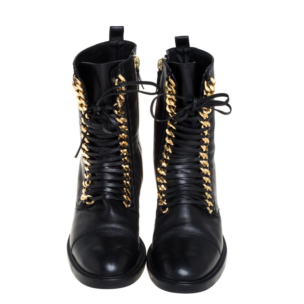 Casadei updates an ageless silhouette with an element of edge with their City Rock boots. Crafted from black leather, the ankle boots are adorned with gold-tone chunky chains along with slender laces. The boots are complete with round toes and