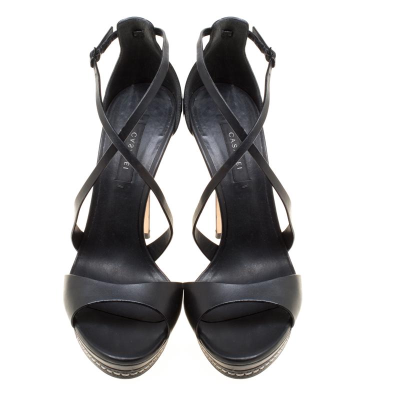 Touch the skies or make the streets your fashion runway, for these black Casadei sandals are anything but ordinary! They are crafted from leather and feature an open toe silhouette. They flaunt cross-over straps on the vamps with buckle fastenings,
