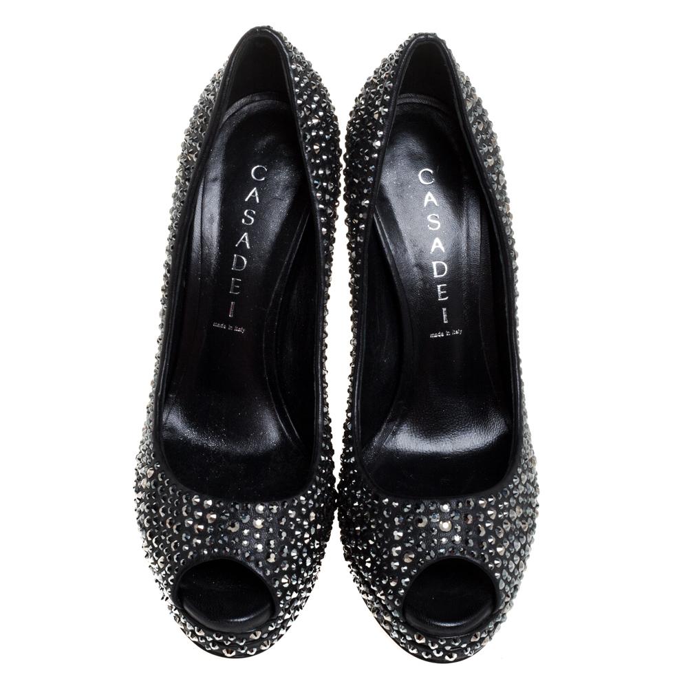 Finesse and poise will all come naturally to you when you step out in this pair of pumps from Casadei. Beautifully embellished with Swarovski crystals, the peep toe pumps are truly breathtaking. They are complete with leather insoles, 14 cm heels,
