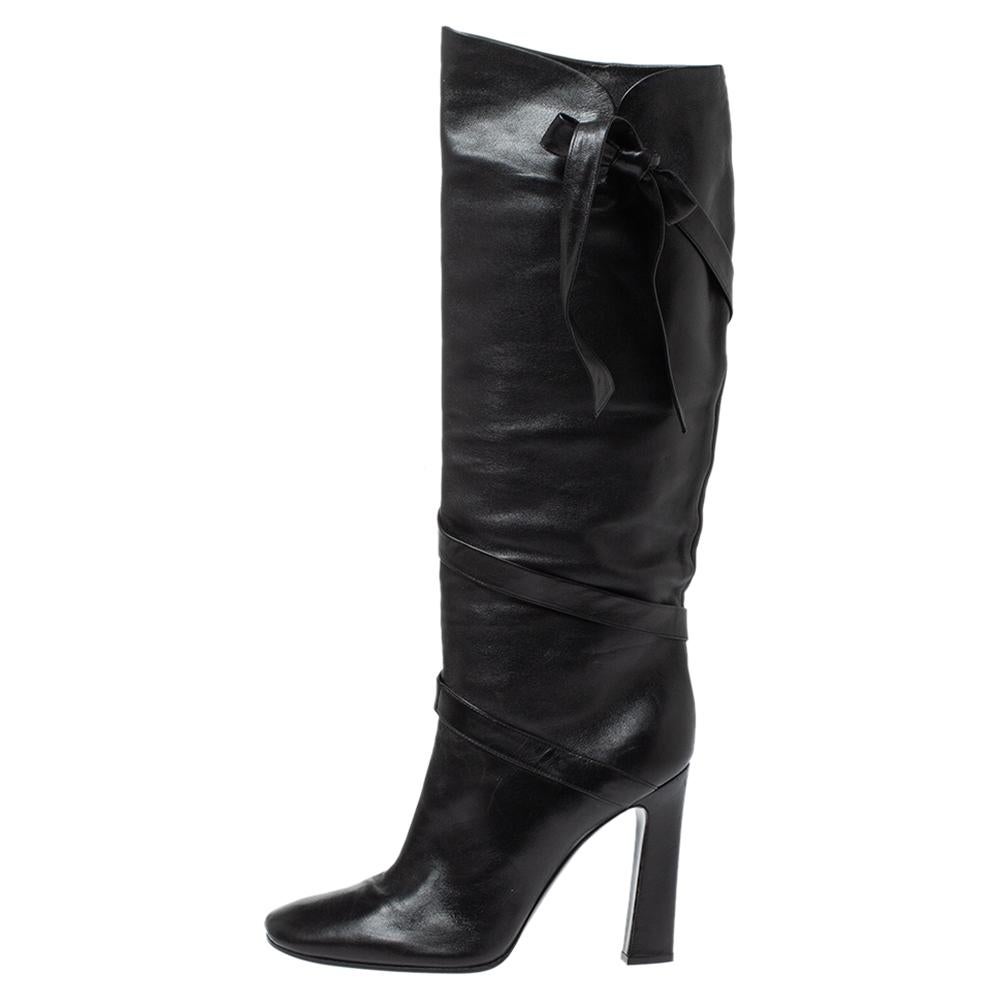 Casadei brings you this fabulous pair of knee-high boots that will give you confidence and loads of style. They've been crafted from leather in a classy black shade and styled in a sharp silhouette with a wrap detail that ends with a bow on the