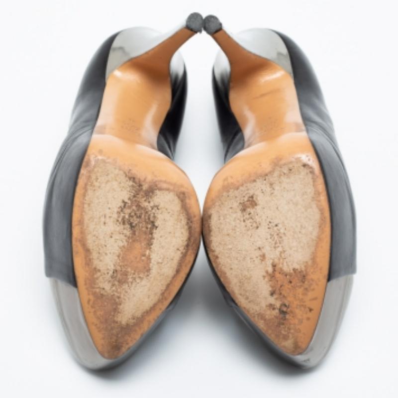 The silver trims against the black exterior lend this pair of Casadei pumps an elegant contrast. Created from leather, it will add an extra dose of style to your outfit. The 15cm heels are supported on platforms to offer you the perfect balance and