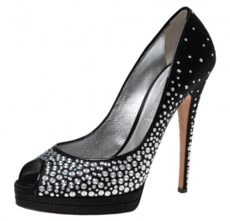 Get set to dazzle the crowds with these peep-toe pumps from Casadei. The black pair is crafted from satin and looks ethereal with its fabulous craftsmanship. The pumps flaunt stud embellishments, solid platforms offering maximum comfort, and a 15 cm