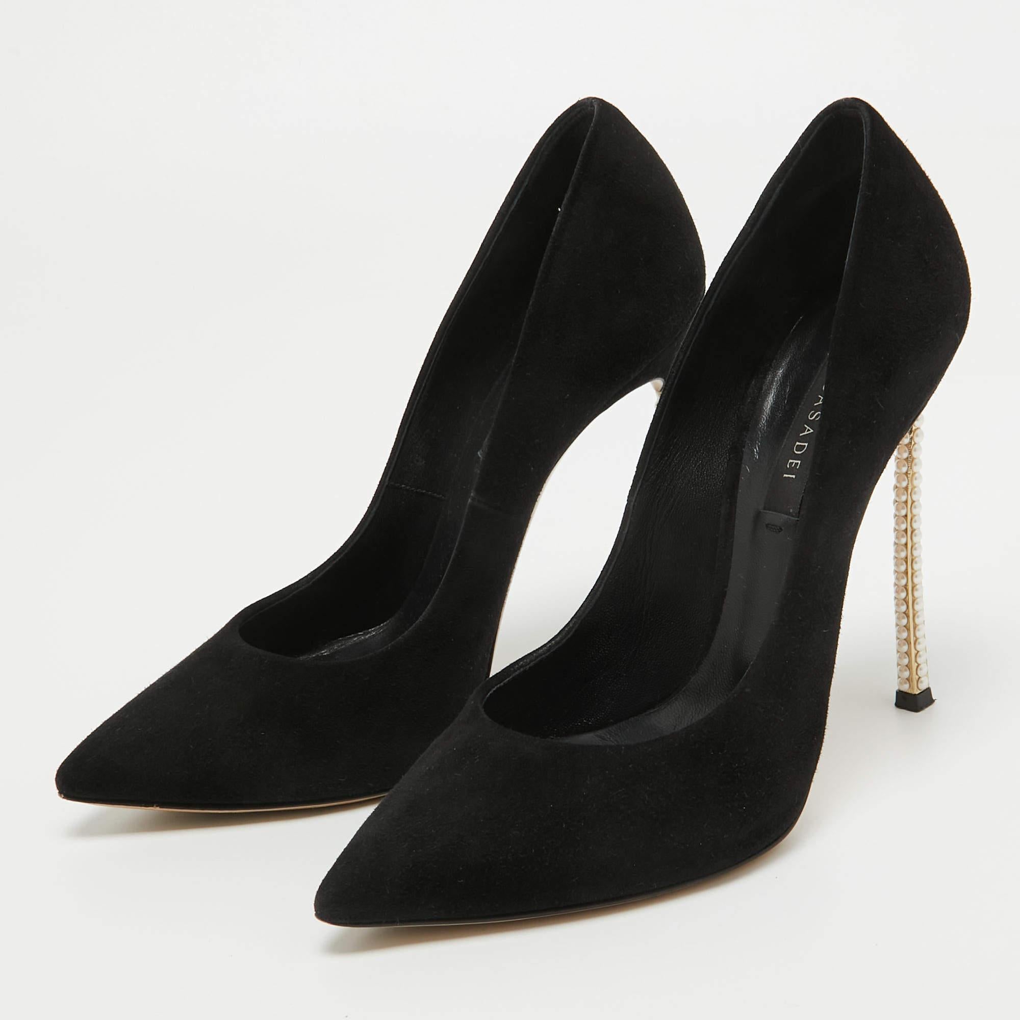 This pair of pumps by Casadei delivers sophistication. The shoes come made from suede in a classy shade of black and are designed with pointed toes and pearl embellished blade heels.