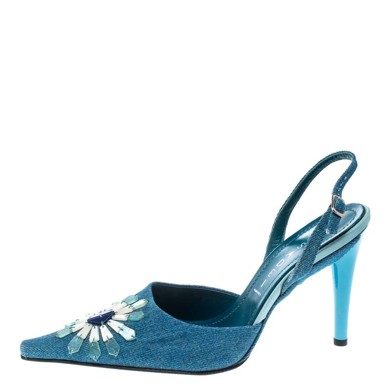 Coming from the house of Casadei, these sandals feature a blue denim body that makes it apt for those celebratory occasions. They are set on towering heels and come embellished with floral appliques on the vamps. They feature slingback straps with
