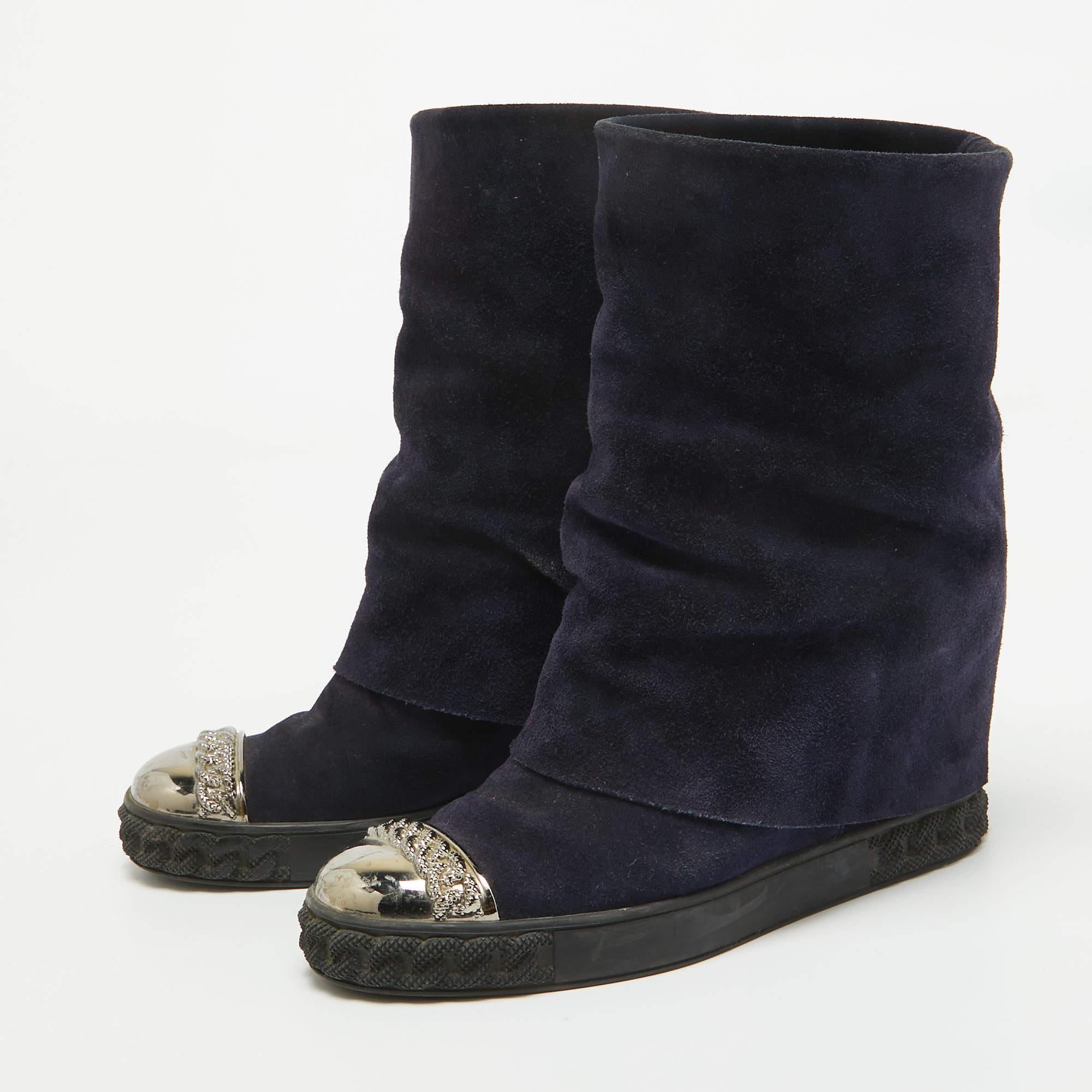 The embellished metal cap toe adds a luxe touch to these Casadei sneakers. Constructed from suede they are equipped with a fold over wedge heel design and rubber soles.