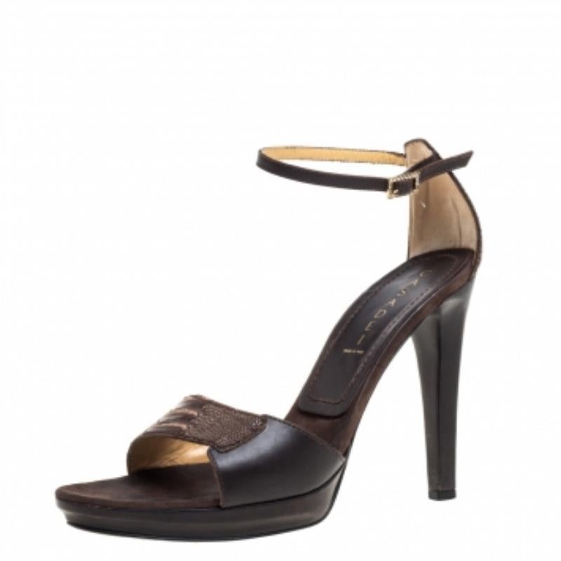 Pair your favorite outfit with these Casadei sandals for a stylish look. These leather and ostrich leg leather sandals are edgy and chic. They have a lovely brown hue, low platforms, buckled ankle straps, gold-tone hardware and 12 cm heels. They are