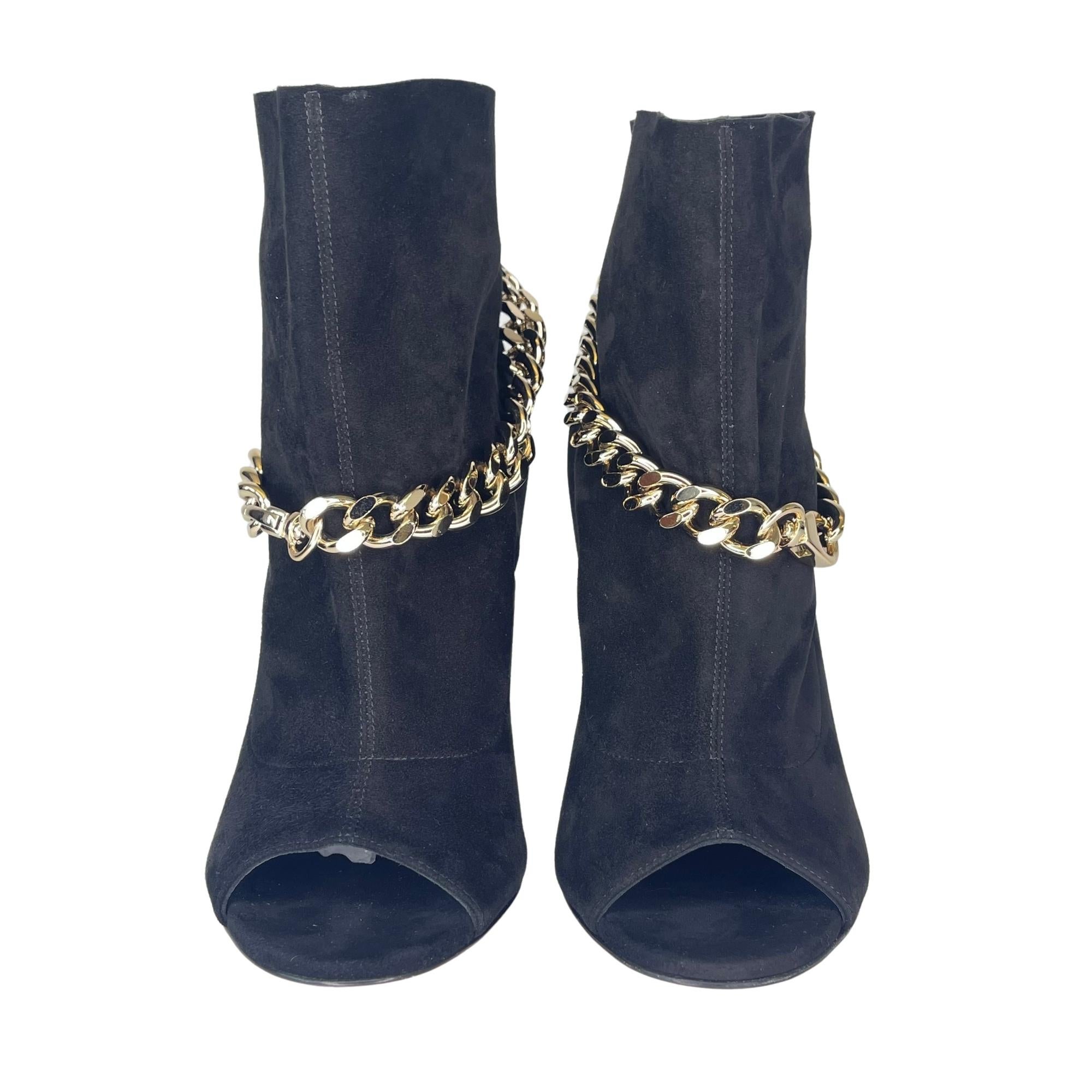 Black suede chain-embellished ankle boots from Casadei featuring an open toe, a slouchy design, a slip-on style, a high stiletto heel and a gold-tone chain embellishment.

COLOR: Black
MATERIAL: Suede
SIZE: 38 EU / 7 US
HEEL HEIGHT: 100 mm /
