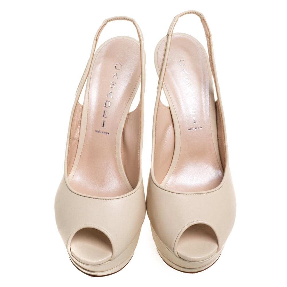 We've fallen head over heels in love with these sandals from Casadei! They are crafted from leather and styled with peep toes, solid platforms, slingbacks, and 14 cm heels. Truly high fashion, this cream pair will effortlessly bring out the