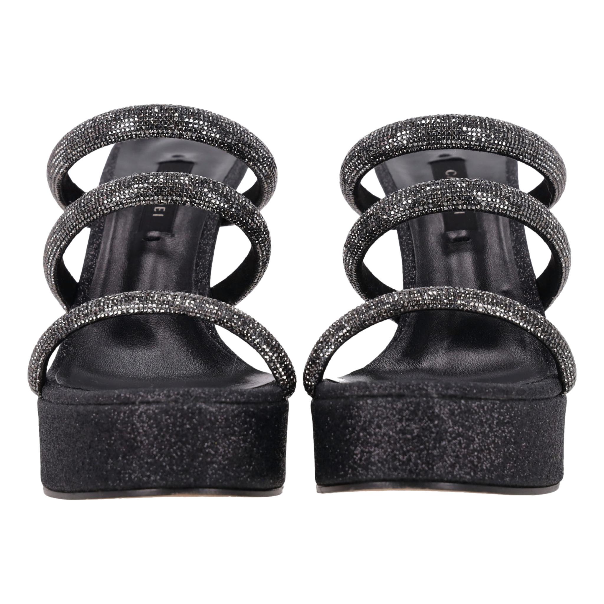 Casadei Crystal Strappy Heeled Mule Sandals

Black leather sandals with triple strap design embellished with black crystals.

Featuring black glitter platform and sculpted heel.

Rrp Approx. £1,000

Size – 38

Condition – Very Good (General signs of