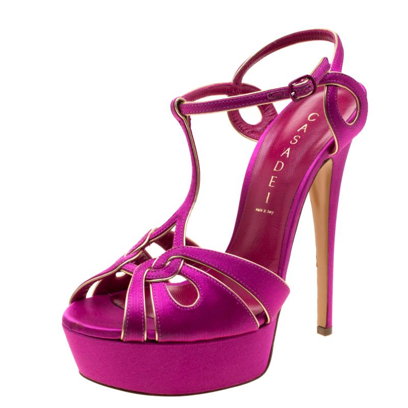 Win praises every time you step out in these sandals from Casadei! Beautifully crafted from satin, they flaunt a t-strap at the vamp and extends into its ankle buckle fastening. The magenta pair carries peep toes, 15 cm heels and a raised platform.