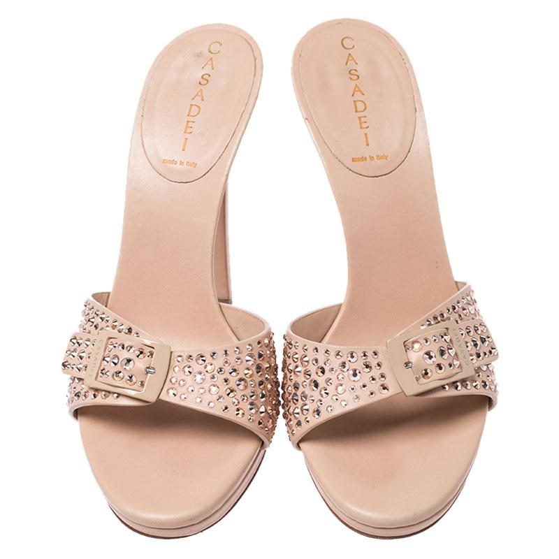 These sandals from the house of Casadei are a fine blend of shine and height. The sandals are designed from the most luxurious of leather for maximum comfort. They feature front straps featuring a buckle and studs and they are balanced on 12.5 cm