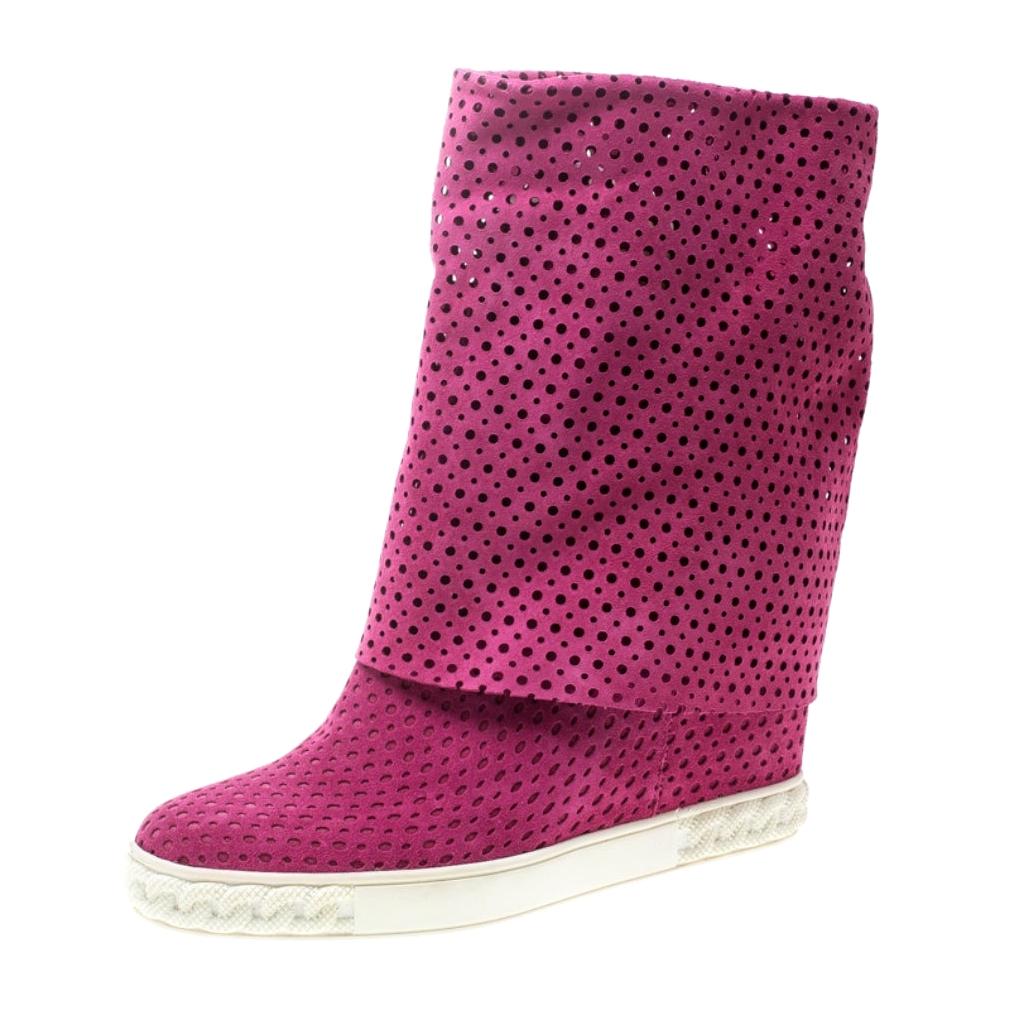 These pink boots from Casadei are just lovely! They are crafted from suede in a perforated design and feature round toes. They are equipped with comfortable leather lined insoles, 10 cm concealed wedge heels and solid rubber soles. Wear them for a