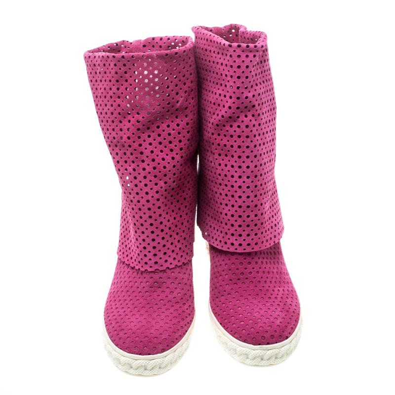 These pink boots from Casadei are just lovely! They are crafted from suede in a perforated design and feature round toes. They are equipped with comfortable leather lined insoles, 10 cm concealed wedge heels and solid rubber soles. Wear them for a