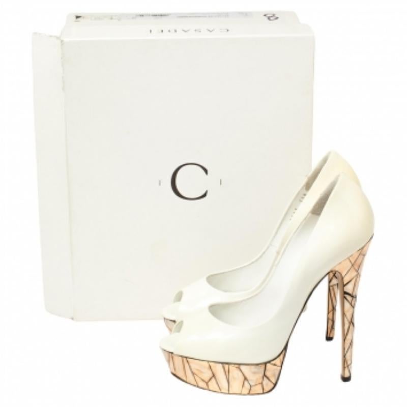 This pair of peep-toe pumps by Casadei will leave you looking like a diva and will add oodles of style to your outfit. They are covered in patent leather and feature mosaic mirror detailing on the 15 cm heels and platforms. Add some style to your