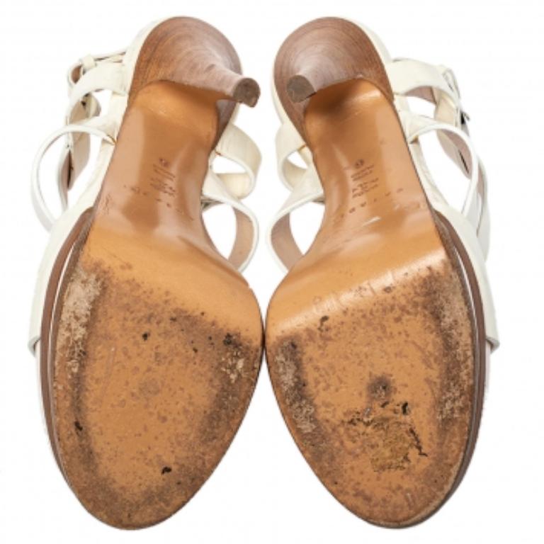 These sandals from the house of Casadei will be a perfect pick to complement almost all your outfits. They are crafted from white patent leather. They are styled with open toes, 14 cm heels, platforms, and silver-tone hardware. Accessorize your