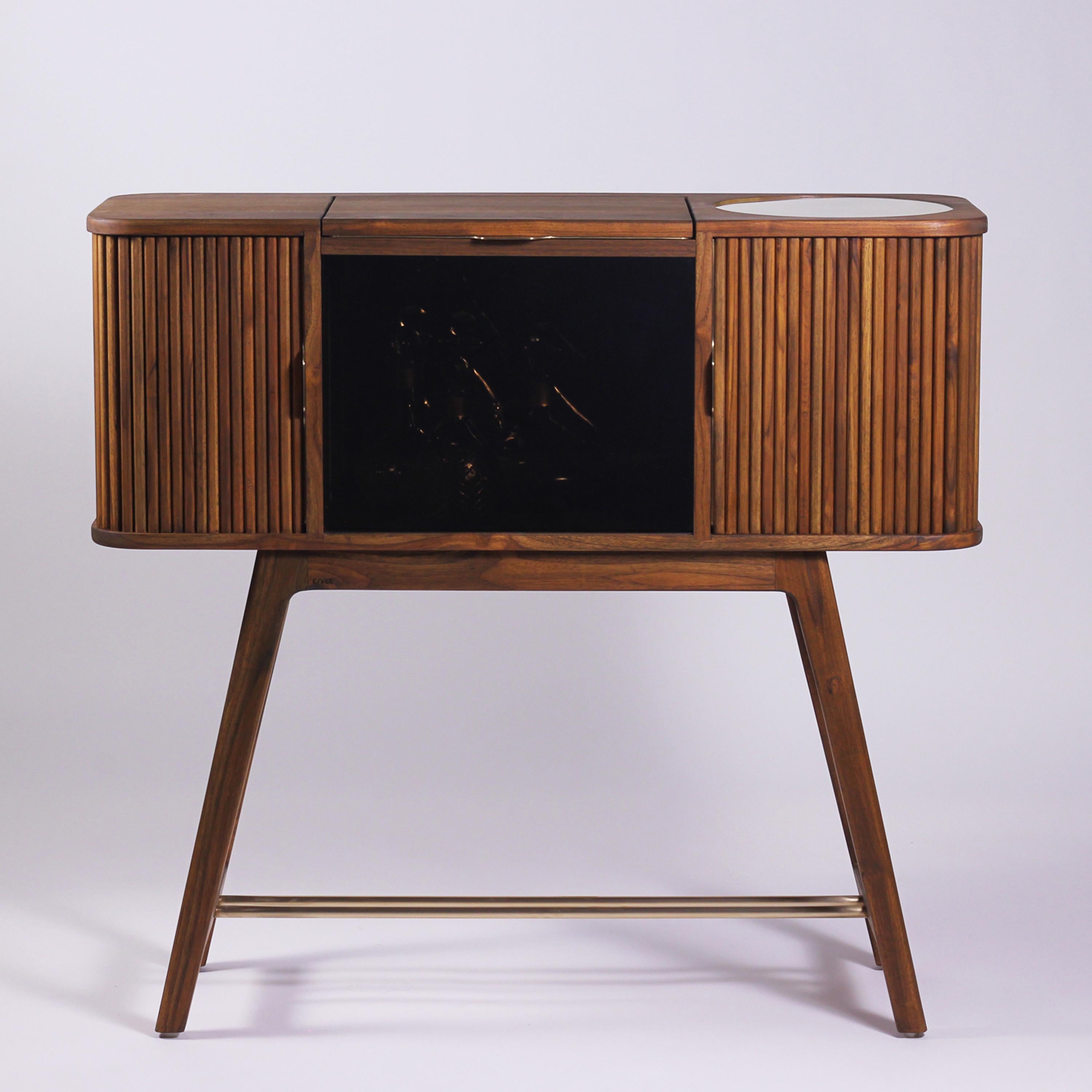 The Casanova teak wood bar cabinet with tambour doors is an original design, developed through an insight-led design process, to inspire a conscious lifestyle and promote mindful entertainment rituals. The design has a nostalgic retro form and is