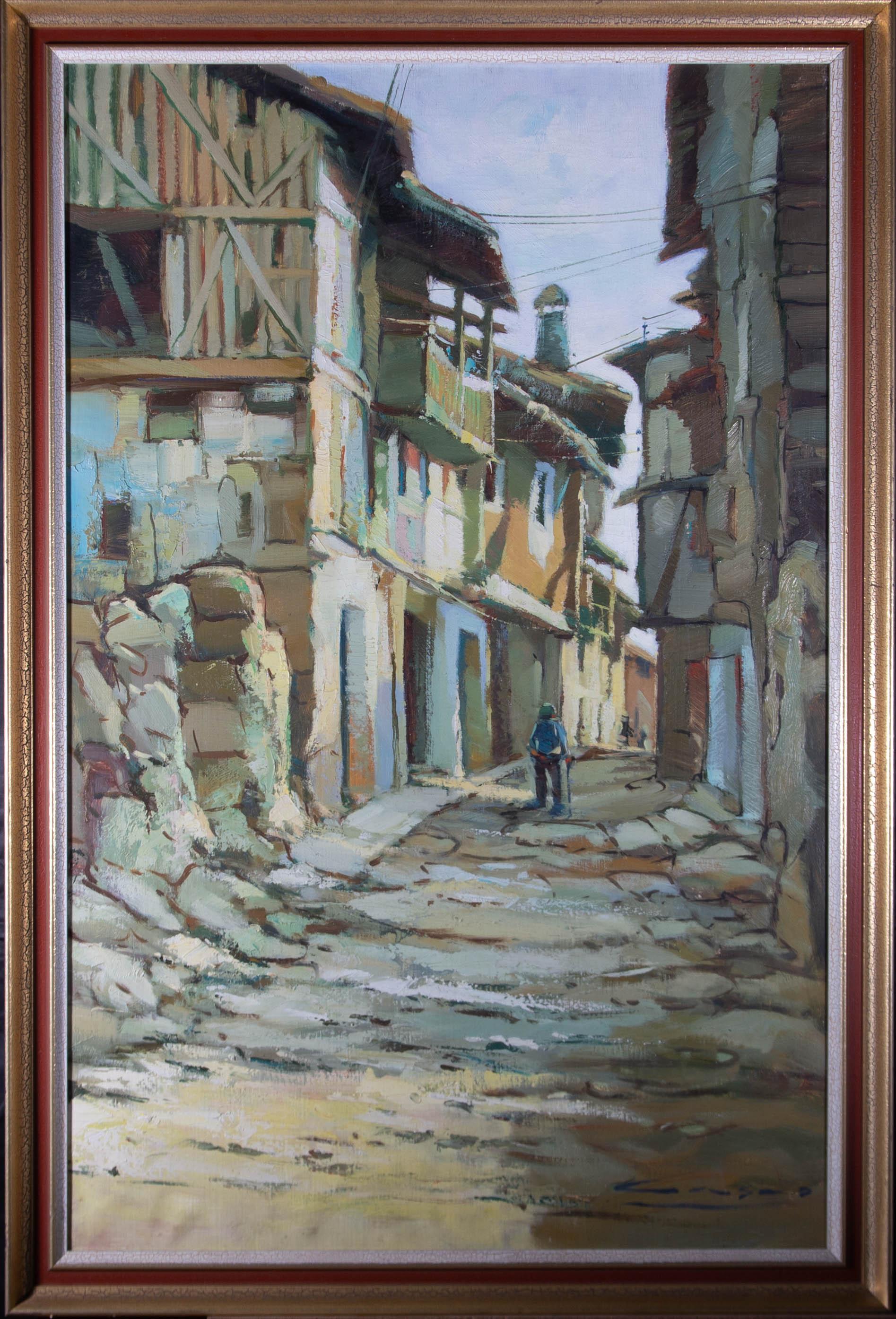 A rustic contemporary oil showing a cobbled Italian street with a figure strolling along the sun dappled path. The artist has signed to the lower right corner and the painting is presented in a contemporary gilt effect frame. On canvas.

