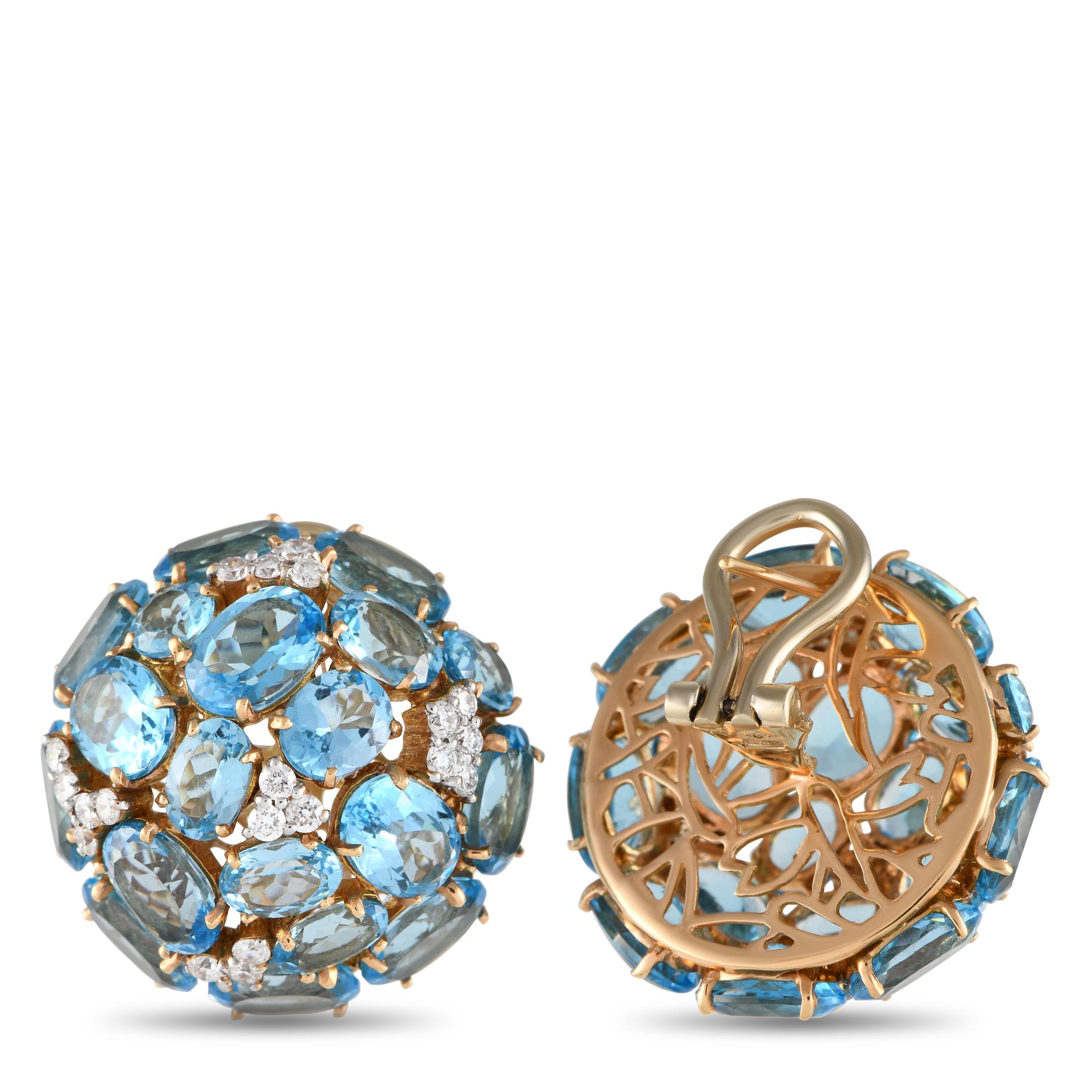Imagine the instant lift these Casato earrings will give to a monochromatic ensemble. The earrings are cast in 18K yellow gold and have a circular base with an omega clasp. A dome of faceted blue topaz gemstones interspersed with clusters of petite