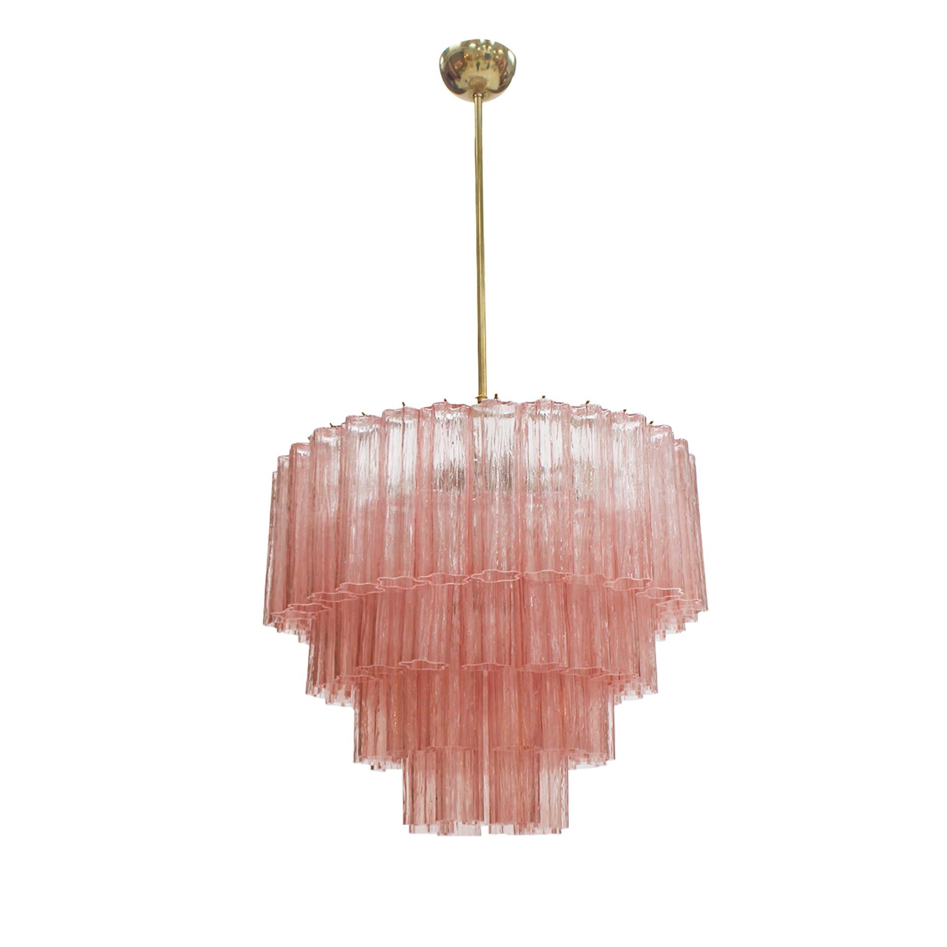 Cascada suspension lamp with a brass structure, featuring four tiers of handcrafted pink Murano glass. Designed for both aesthetic refinement and functional illumination, it is equipped with six E14 socket light points. This Italian-made piece
