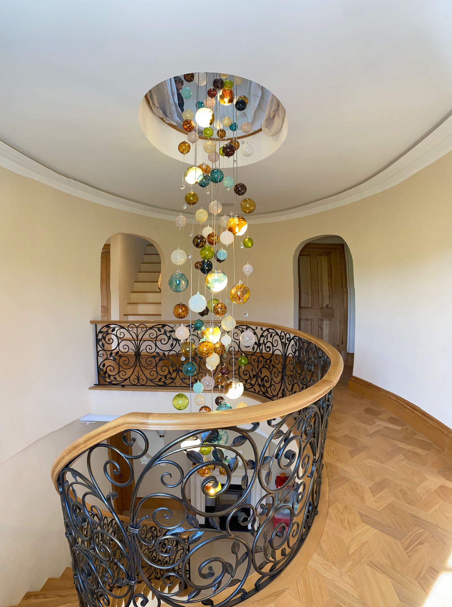 This contemporary chandelier is an Cascade design and features over 150 individually blown glass spheres. The glass is blown in Europe and the UK and the chandelier is designed and handcrafted in our studio in South London. 

This chandelier is