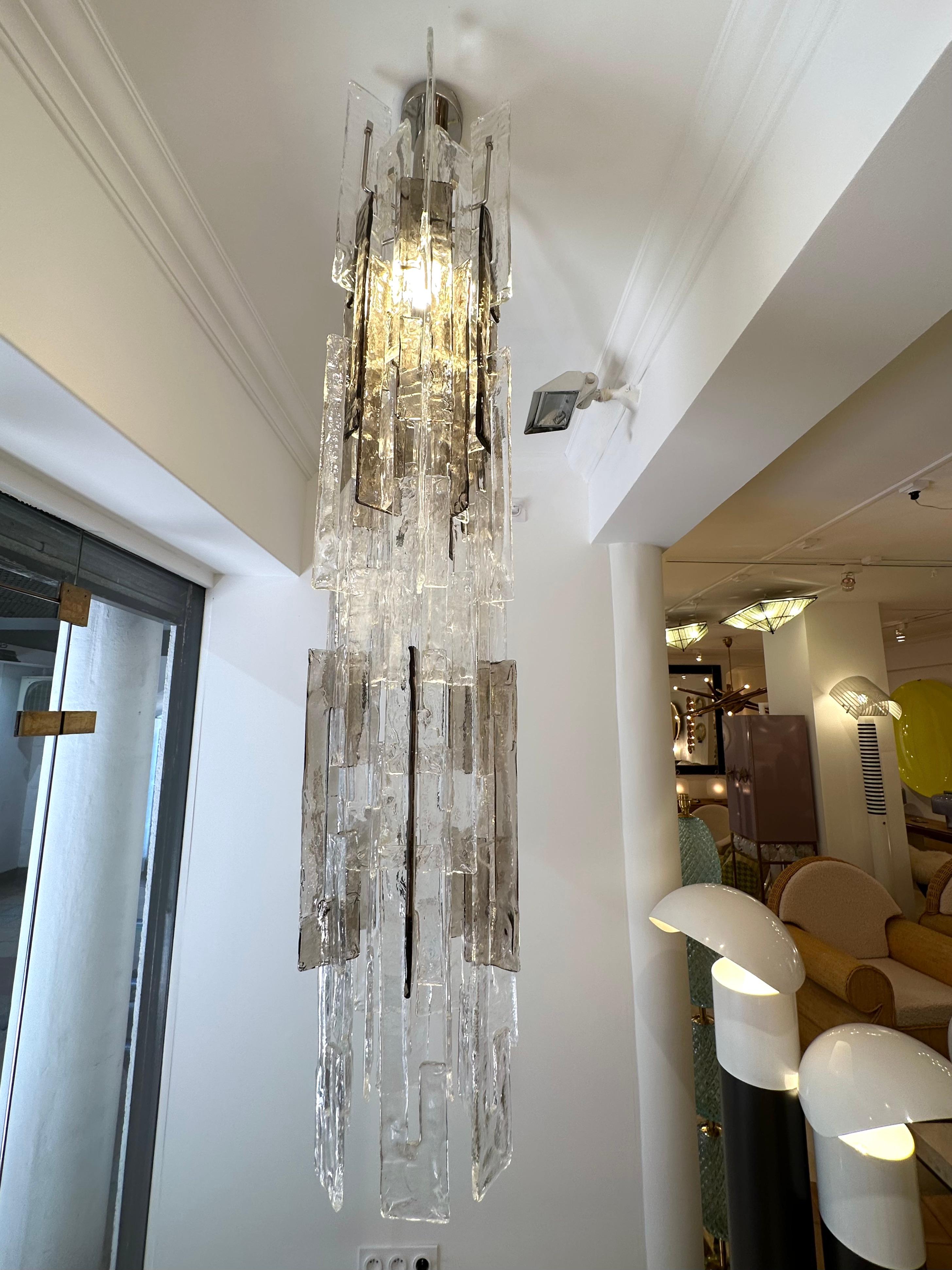 Mid-Century Modern Space Age Cascade Chandelier ceiling pendant lightning in smoke gray and clear Murano glass and metal, model LS101 by Carlo Nason for the manufacture Mazzega. Famous manufacture like Venini, Veronese, La Murrina, Aldo Nason,