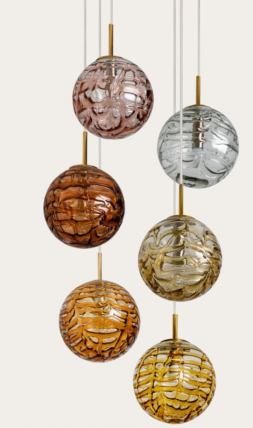 Absolutely amazing huge ceiling mount pendant light fixture with eight different globes by Doria Leuchten, manufacturered around 1960s. With hand blown murano glass globes in 11.8