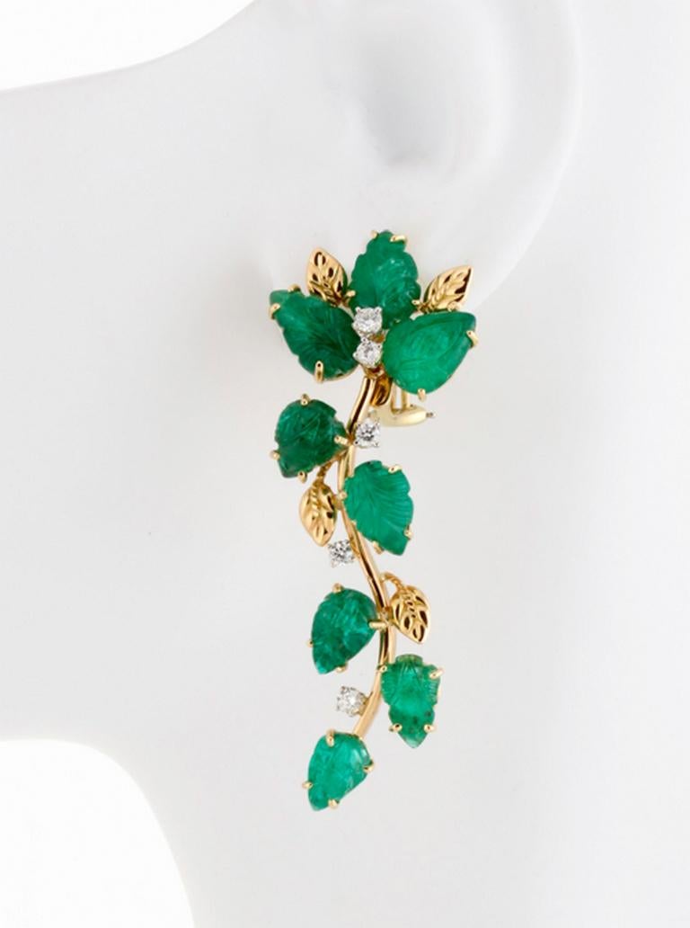 Cascade of Emerald Leaves Earrings for pierced ears. 

Sixteen hand-cut Emerald Leaves in four different sizes, set among 18k gold leaves and small brilliant round diamonds, cascade down on flexible and balanced 18k frames. The largest leaves are