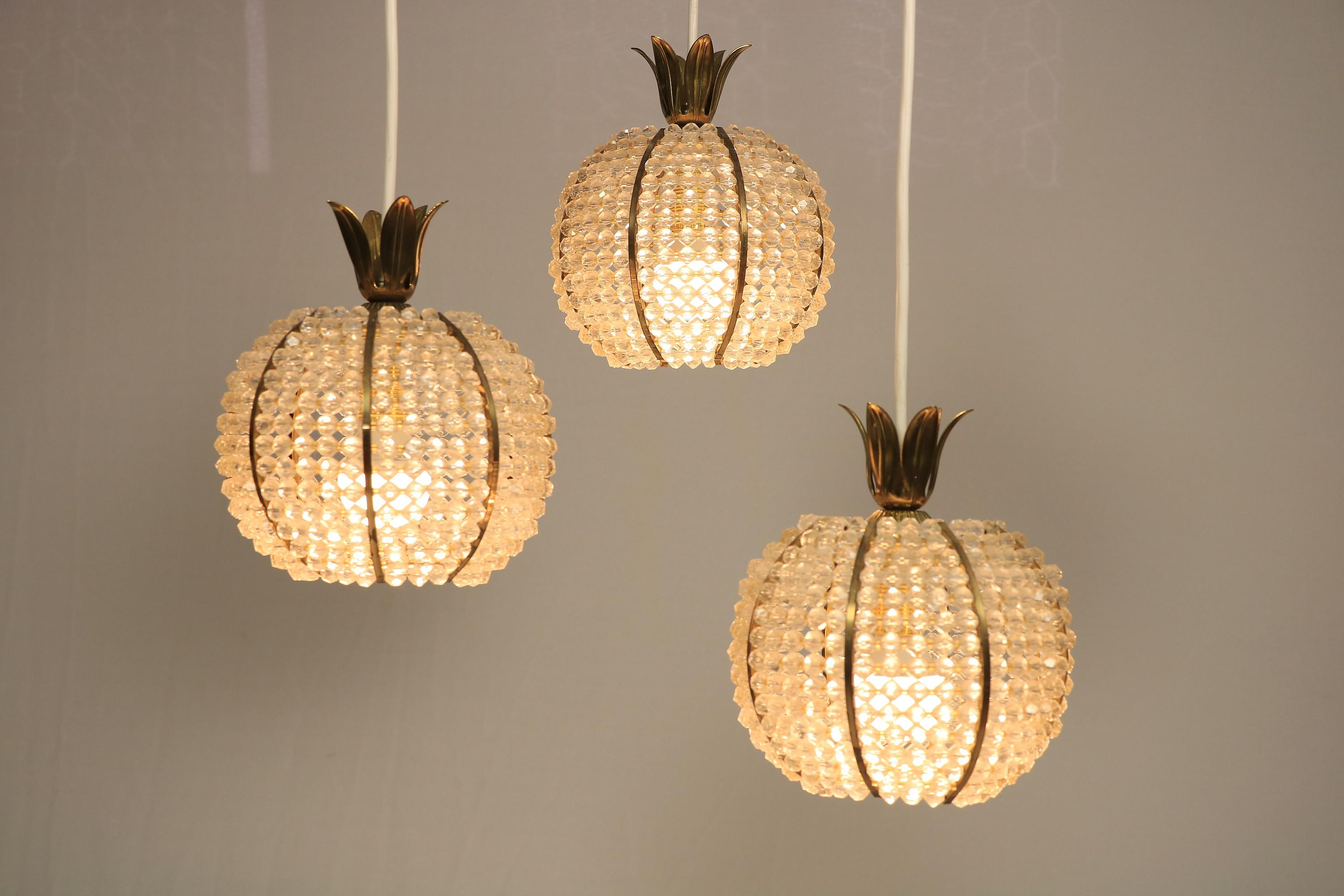 Rare, extraordinary cascade lamp by Emil Stejnar.
Manufacturer: Nikoll, Vienna, Austria.
 
The balls consist of many acrylic beads, with a brass top. Design of a pineapple.
 
The baldachin with manglass beads is also interesting.
 
The lamp has been