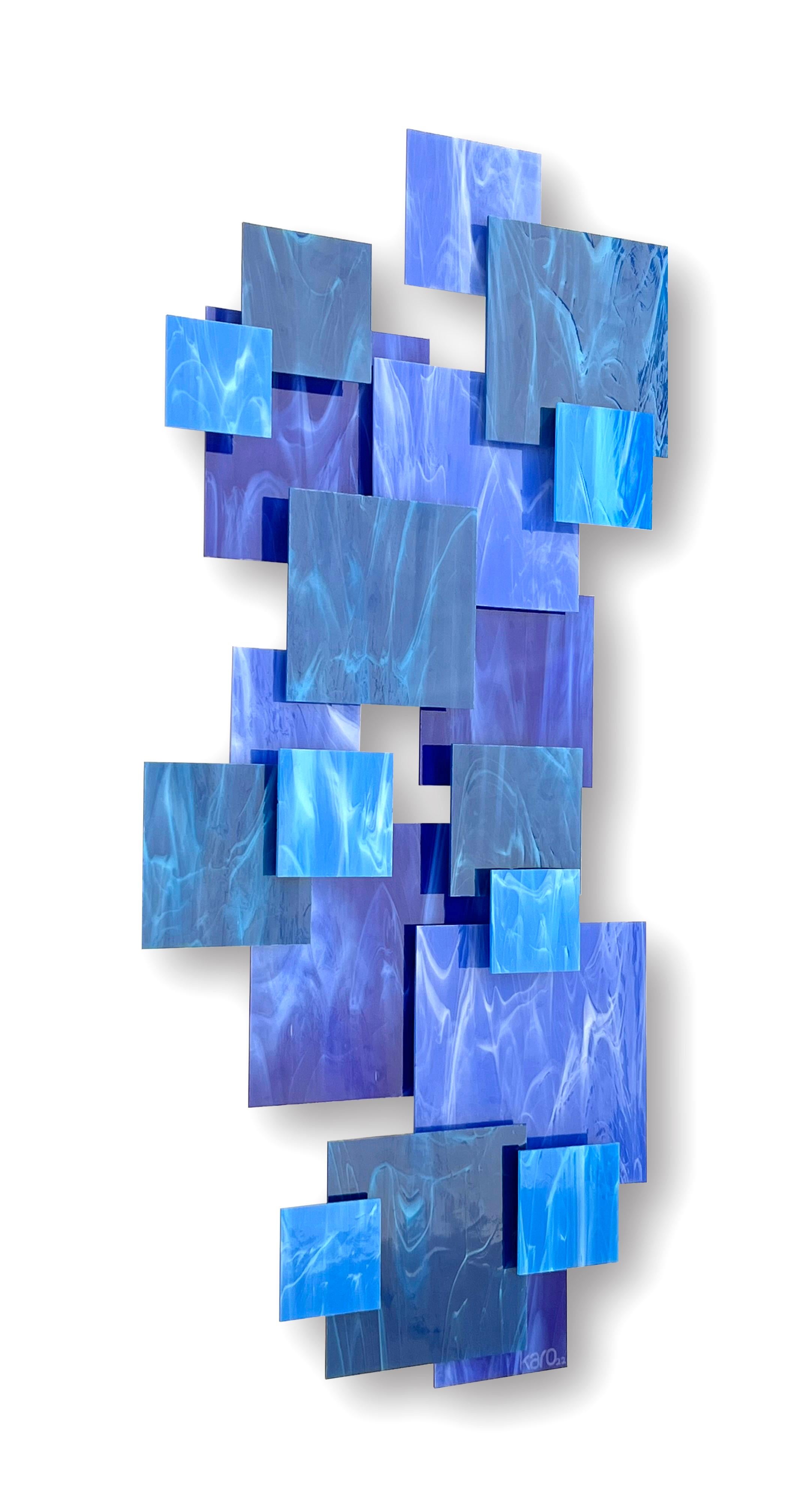 Individual pieces of glass are hand cut and placed over a welded metal frame on different elevations to create a 3D dynamic and harmonious composition. Each piece is hand created by the artist Karo Martirosyan in his studio in Los Angeles. With a