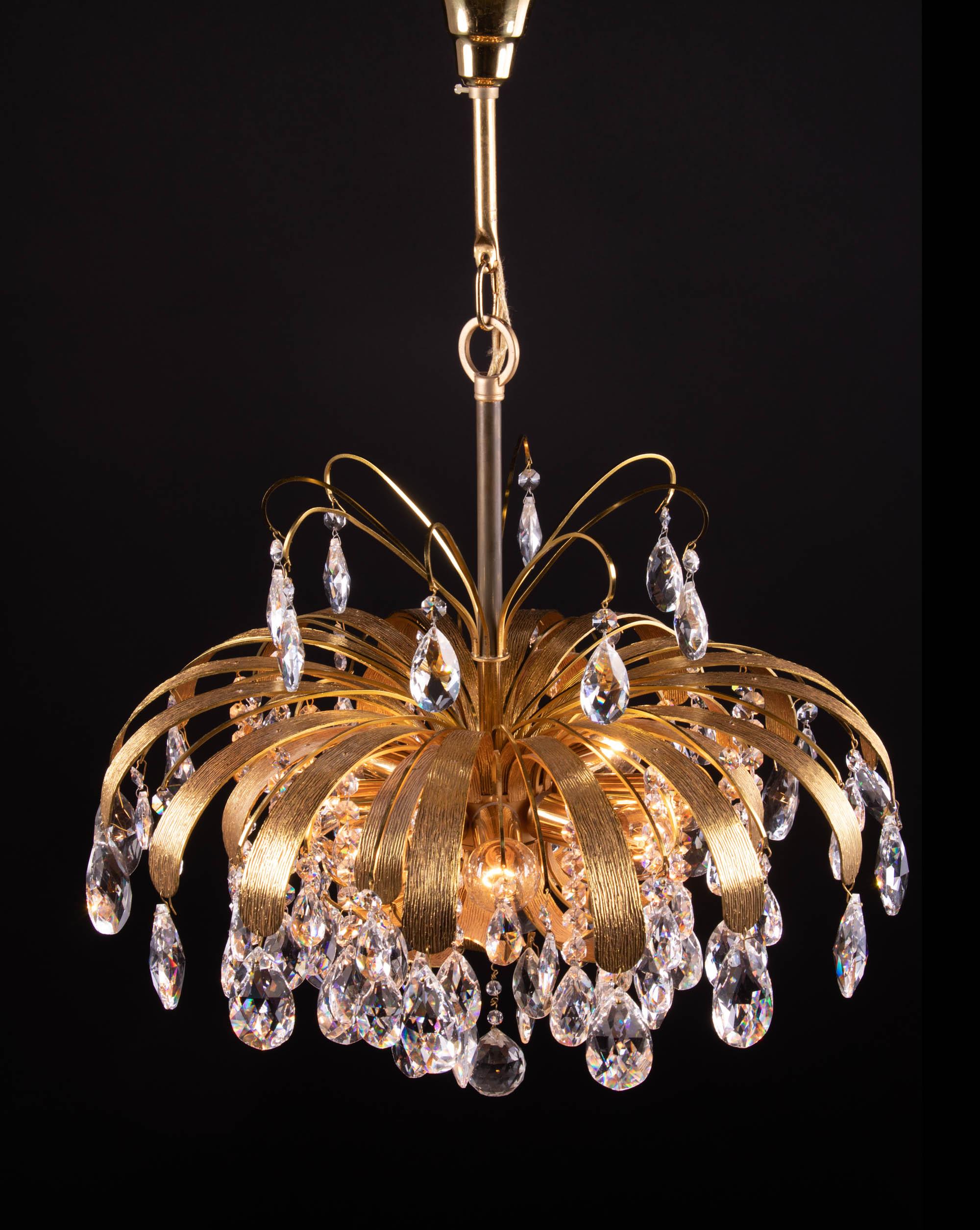 Beautiful cascading gilt brass leaf crystal chandelier designed by Christoph Palme. Chandelier illuminates beautifully and offers a lot of light. Gem from the time. With this light you make a clear statement in your interior design. A real