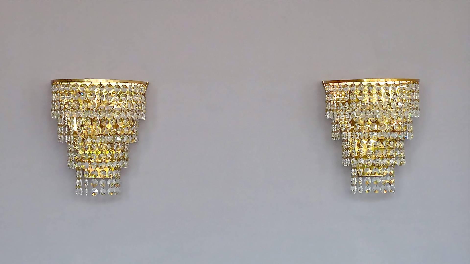 Precious midcentury pair of cascading waterfall crystal glass sconces designed and executed in the 1960s and made by the famous German first class lighting company Palwa. The beautifully handcrafted and manufactured four-tier wall appliques are made