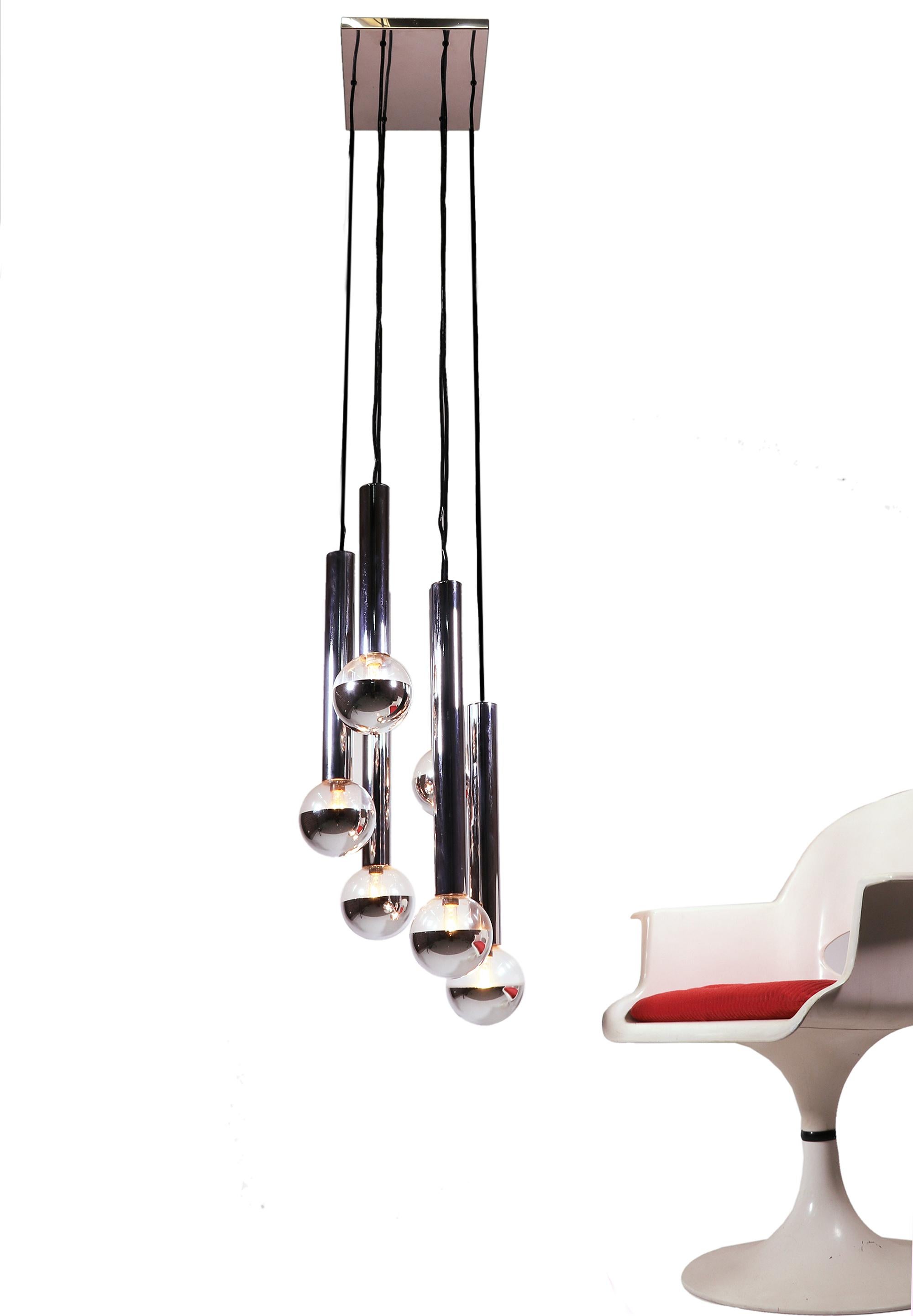 Elegant space age sputnik ceiling light with six partially mirrored glass shades on chromed metal tubes and frame designed by Motoko Ishii. All lampshades are made of wafer-thin glass, which is optically similar to light bulbs. 

The height of the