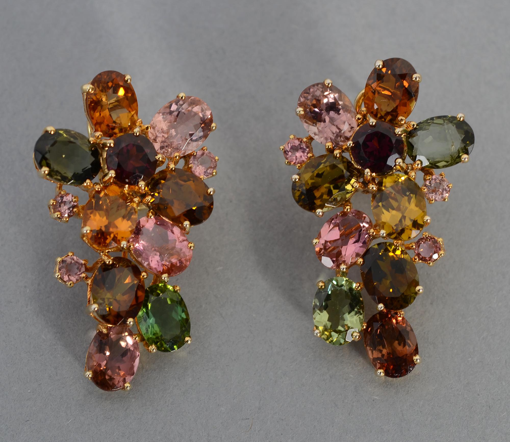 Multigem cascading earrings with oval stones that include: amethyst; garnet; citrine; tourmaline;and morganite. The faceted oval stones have several smaller round stones on either side. The variety of rich colors make these wearable with virtually