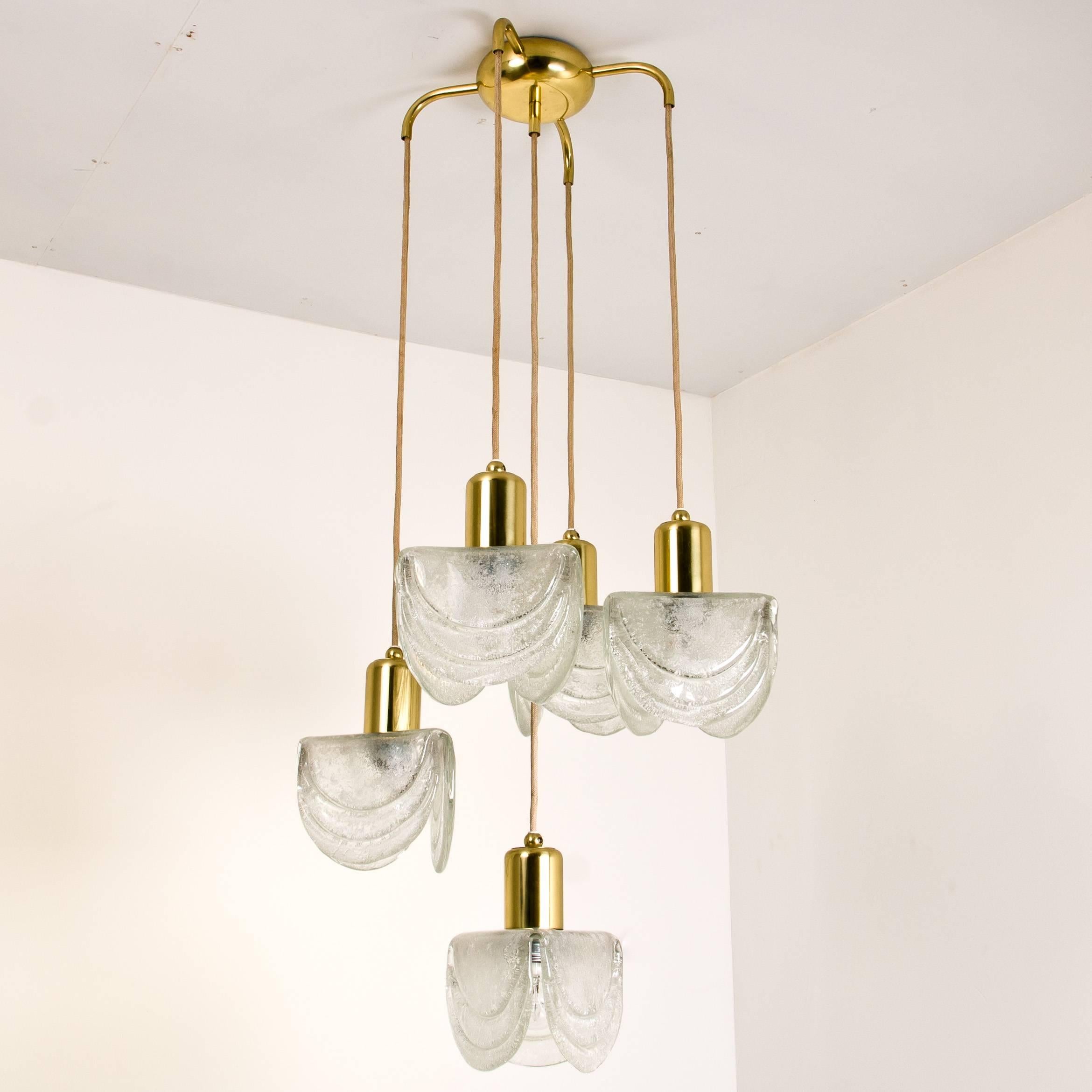 A beautiful and high quality five-tier textured hand blown glass and brass cascading chandelier, made in Austria in the early 1960s. Each glass lampshade requires an Edison E27 screw on bulb. The lamp works on 220V as well as 110V. The cables can be