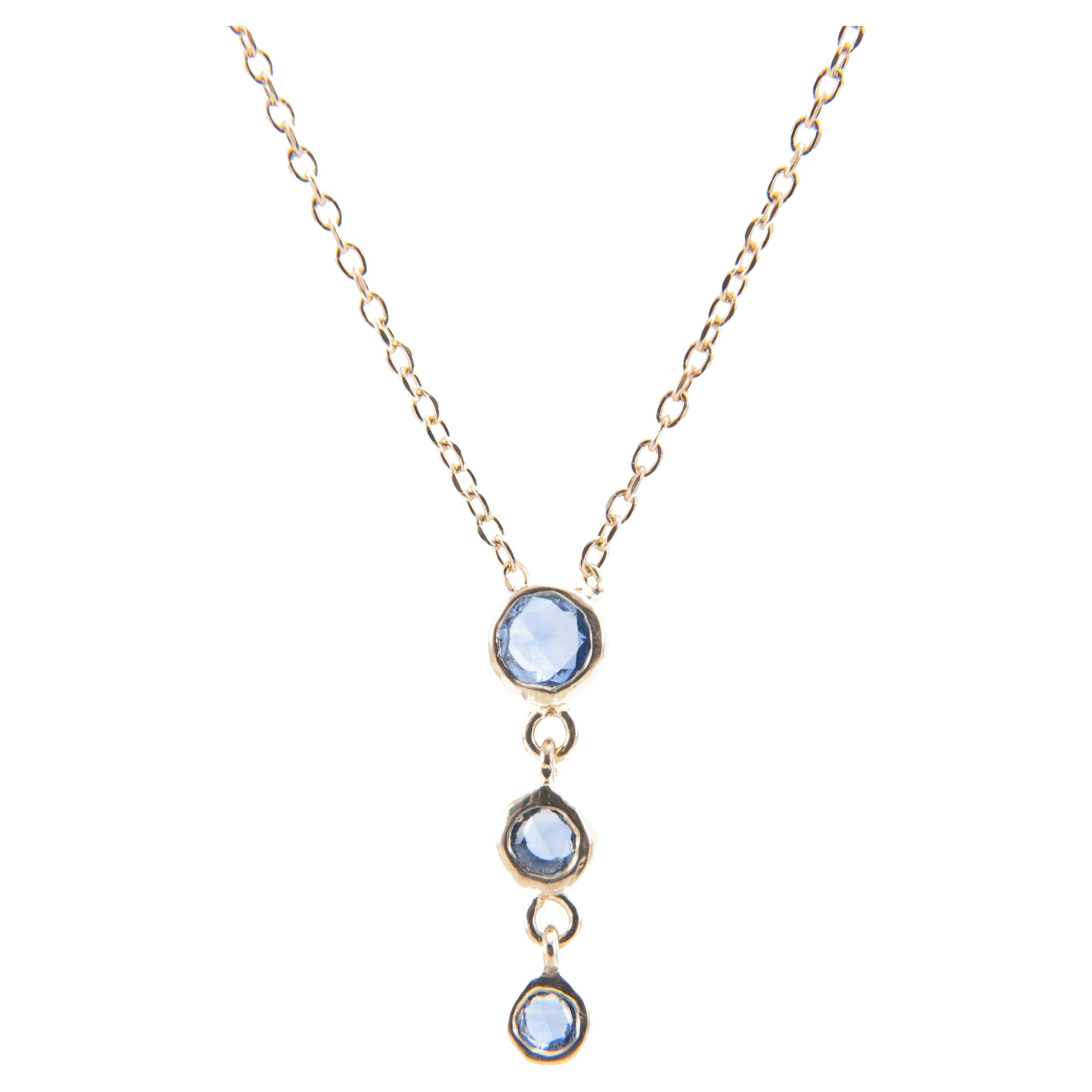A row of graduated rose cut blue sapphires adds just the right amount of sparkle to this delicate necklace.

18K yellow gold chain
Drop pendant of 3 graduated rose cut blue sapphires
0.25 total carat weight
16 inch chain